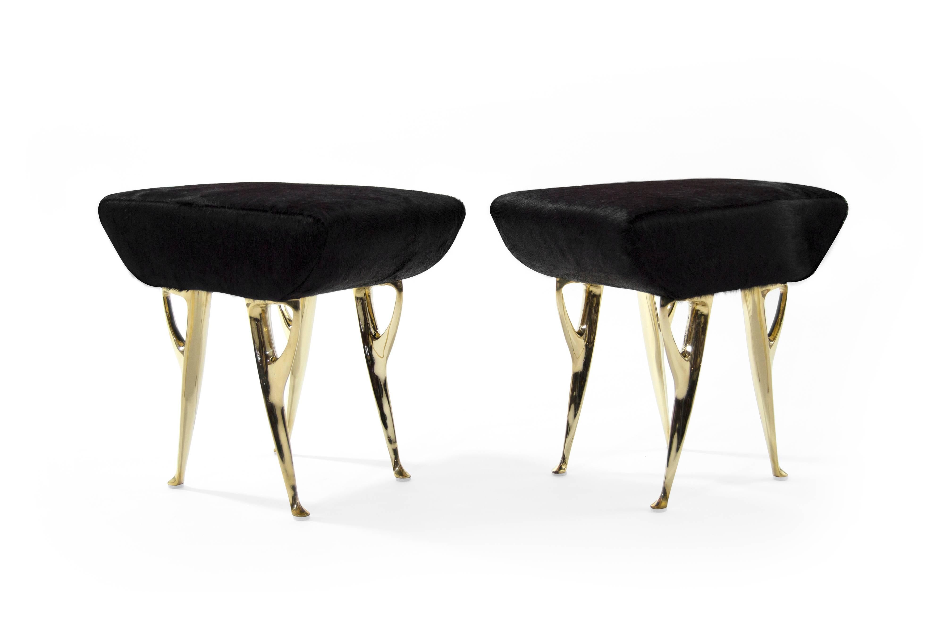 A pair of lovely modern stools, originally manufactured in Italy, circa 1950s. 

Solid brass legs newly polished, upholstered in black hair on hide.