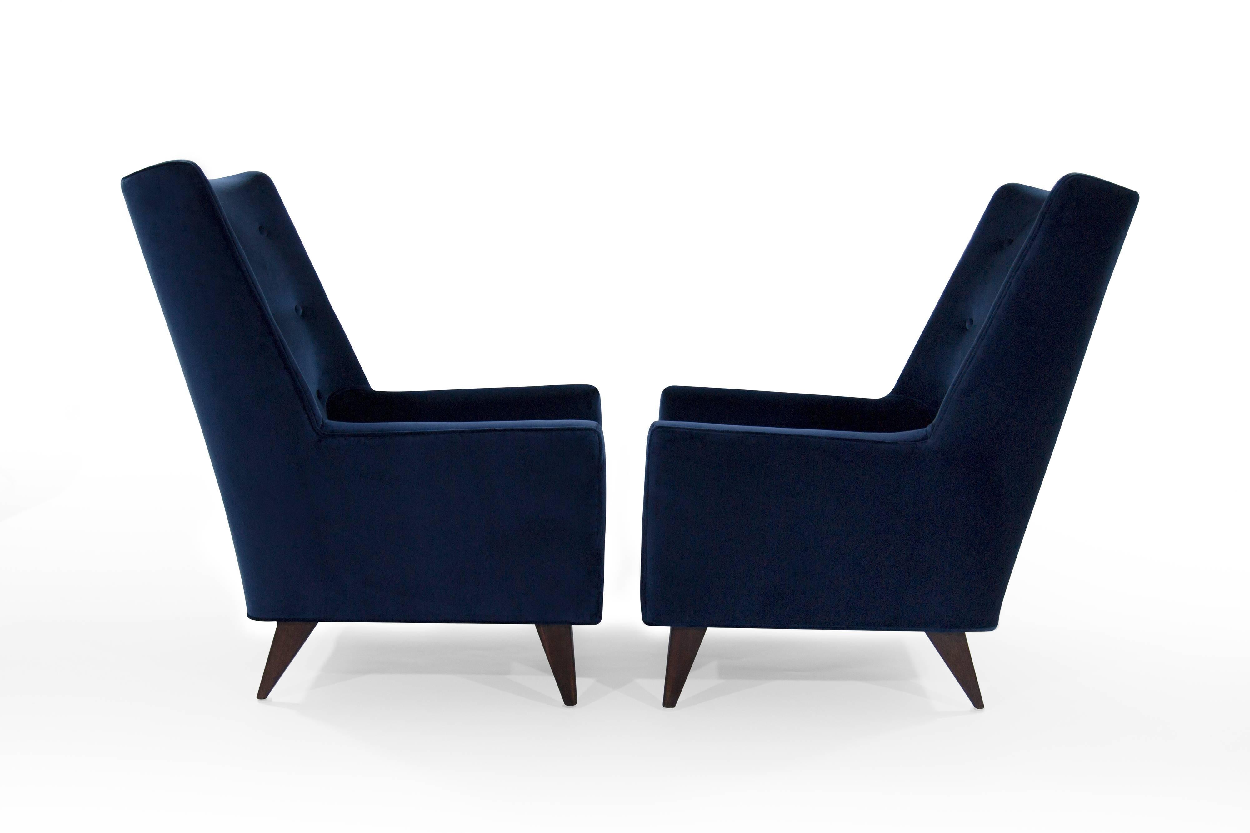 Rare high back lounge chairs designed by Harvey Probber, circa 1950s. 

Newly upholstered in navy blue velvet. Walnut legs fully restored.

Available and priced individually.