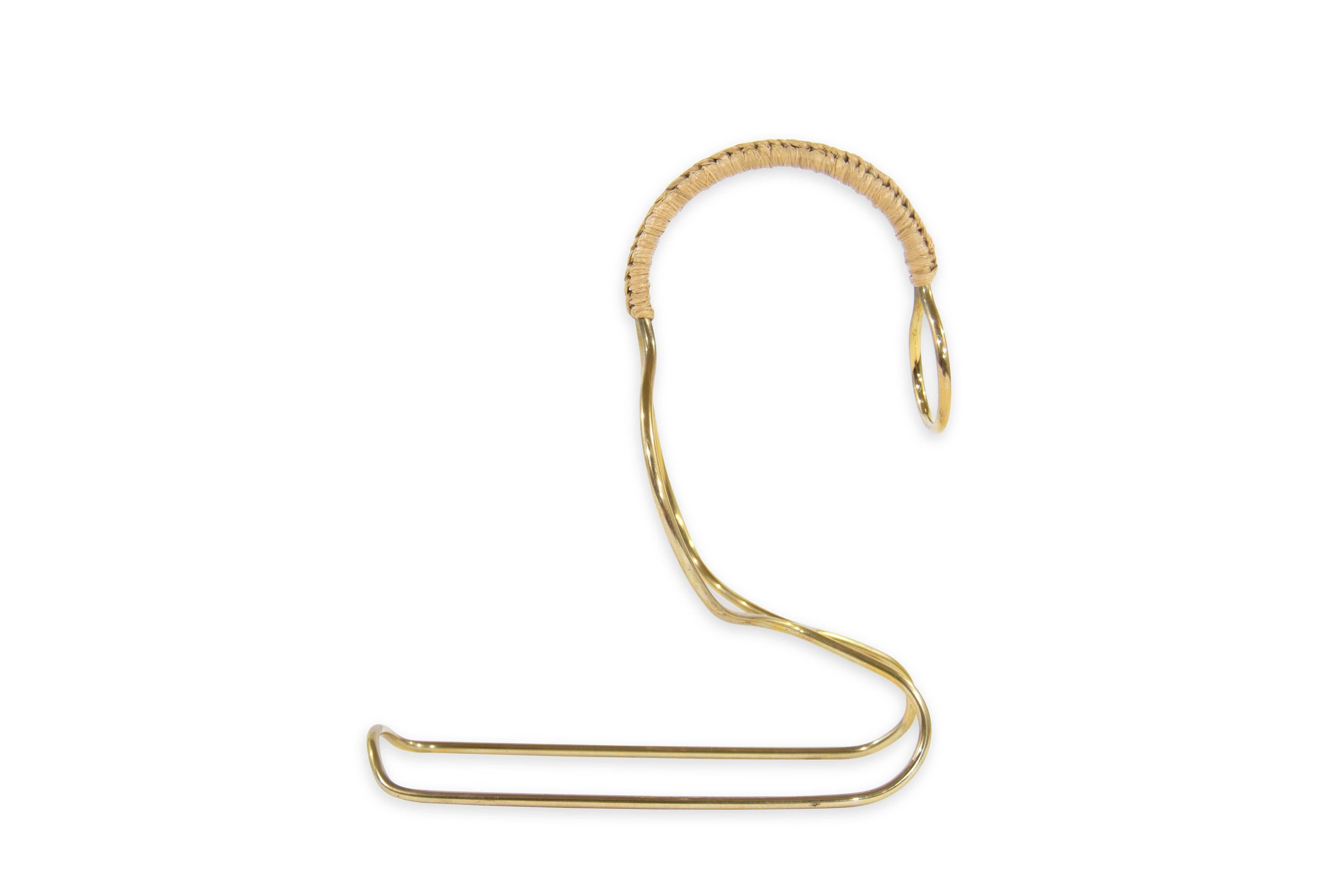 Smart and venerable, the unmistakable styling of Carl Auböck, a brass wine server with a woven wicker handle.