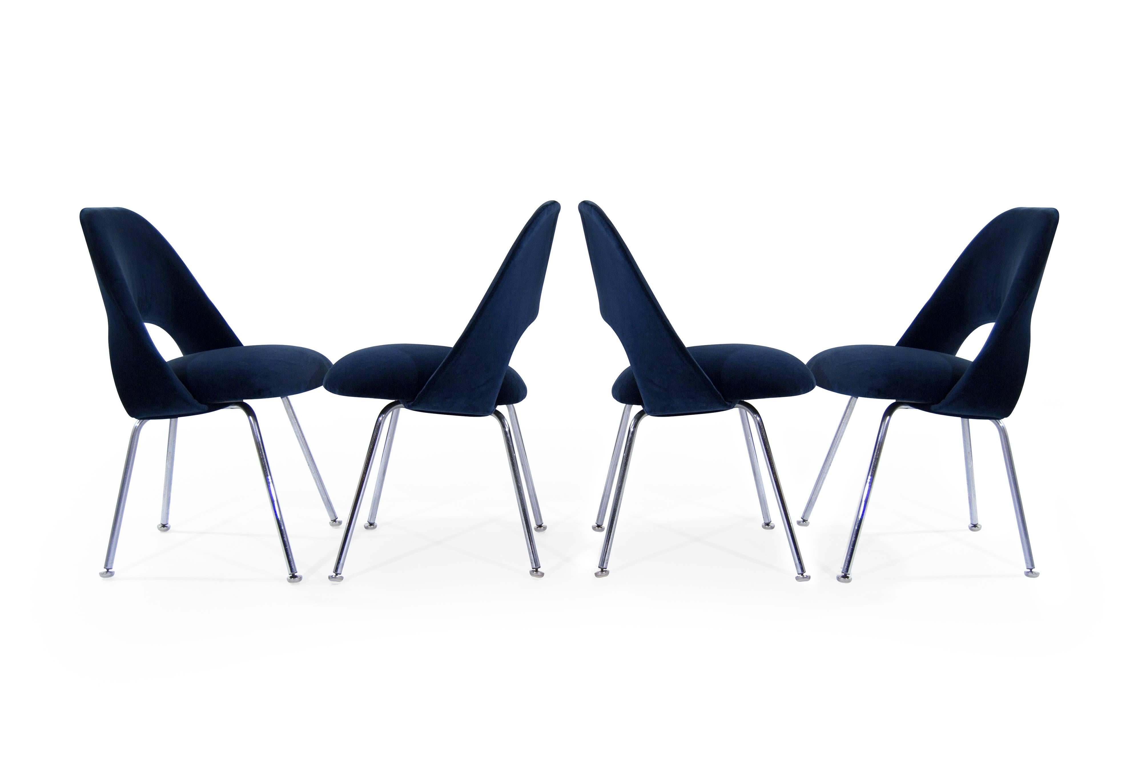 A set of four newly upholstered executive side chairs by Eero Saarinen, newly upholstered in navy velvet.