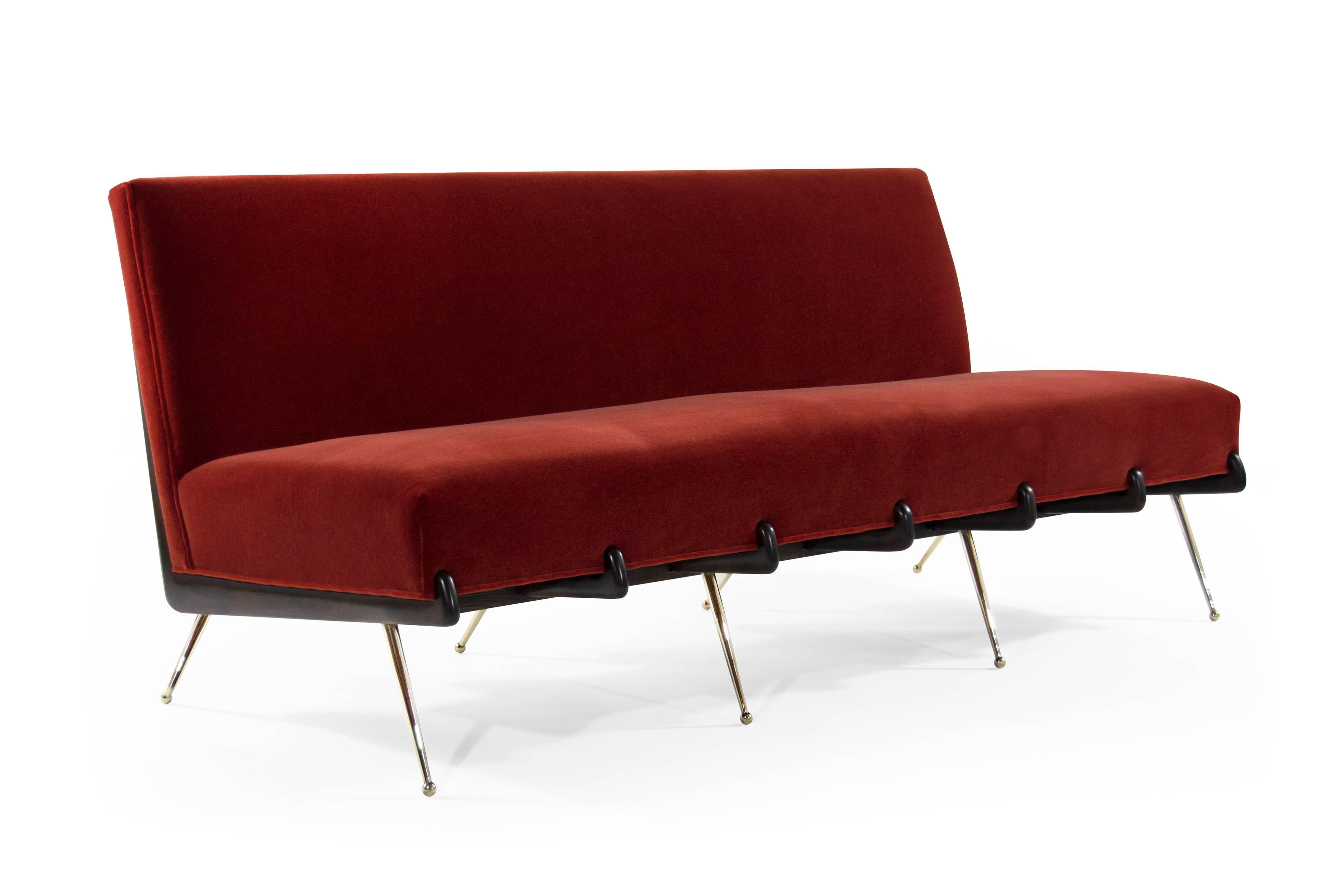 Rare sofa in the style of Italian designer Gio Ponti, circa 1960s.

Boomerang shaped walnut frames fully restored to their original dark walnut finish, newly upholstered in rust red mohair. Thin tapered brass legs newly polished. 