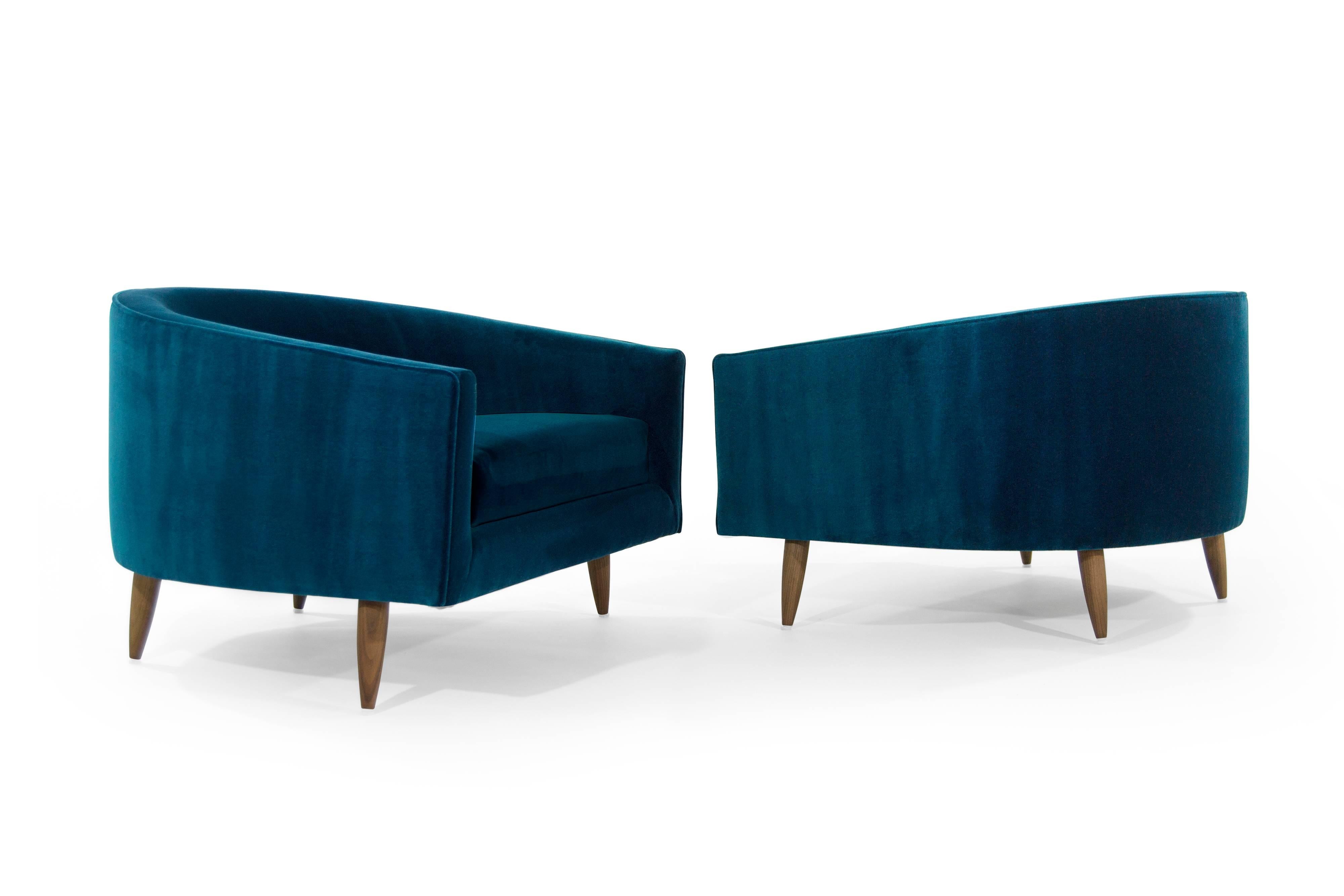 Rare pair of low and wide profile, lounge chairs designed by Adrian Pearsall for Craft Associates. Extremely comfortable! Perhaps one of Adrian's best designs.

Newly upholstered in aqua plush velvet by Holly Hunt. Walnut legs fully restored.
 