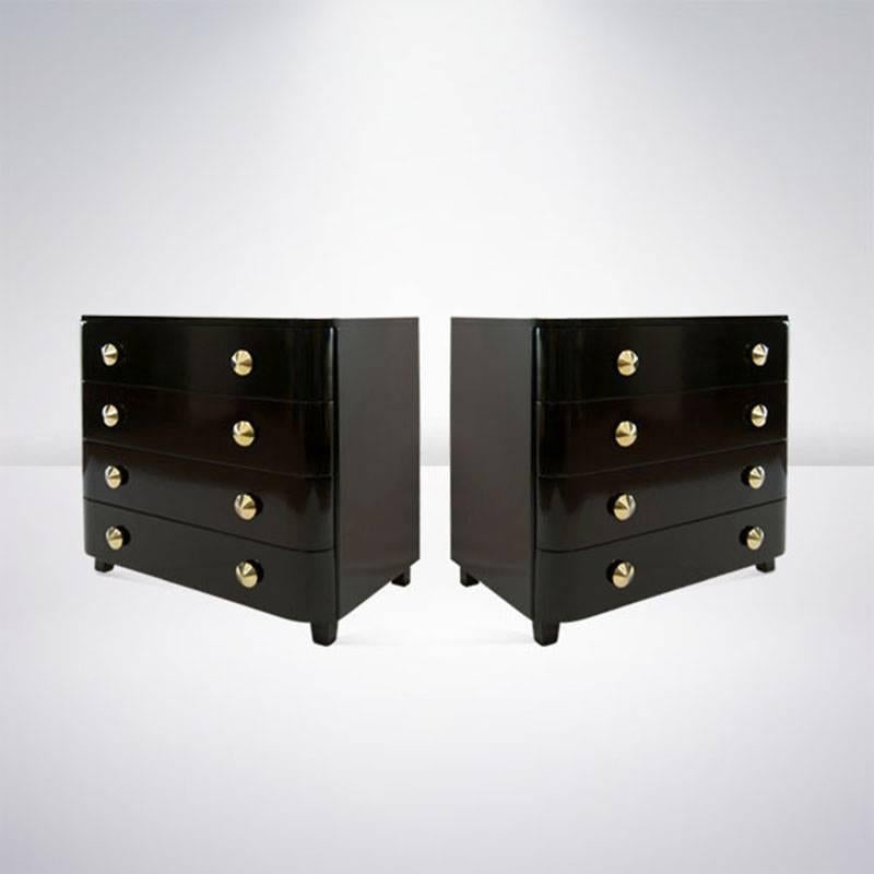 Early design by Paul Frankl pair of bachelors chests or dressers, circa 1940s.
Each chest features four drawers for ample storage as well as dome-shaped solid brass pulls newly polished. Chests have been newly refinished in a high gloss dark