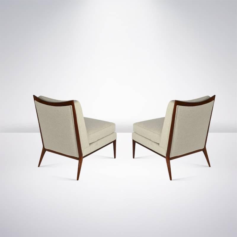 Pair of chairs designed by Paul McCobb for Directional, circa 1950s. Walnut completely restored, newly re-upholstered in beige chenille.