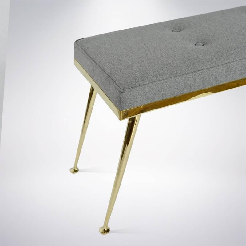 Old meets new in this edited version of an Italian coffee table turned bench by Stamford Modern.

Custom brass legs have been mounted under a 1950s brass frame newly upholstered in grey wool.

  