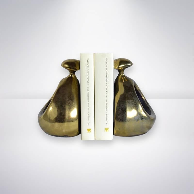 Sculptural pair of bronze bookends in a rounded triangle form with bullet like finials, an open sculptured body with a flared base. By Ben Seibel for Jenfred Ware. American, circa 1960.
