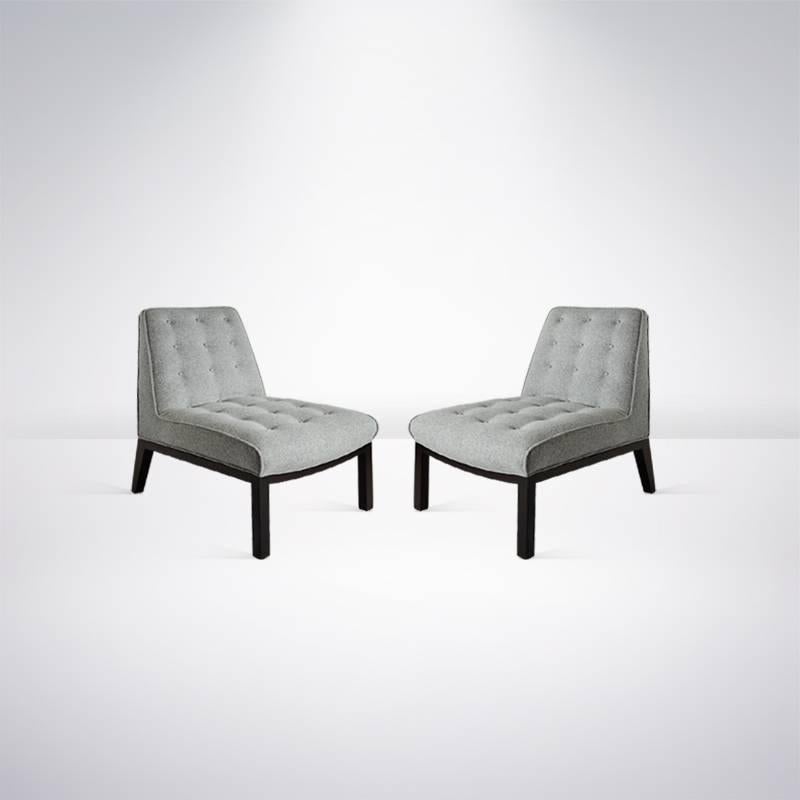 Classic pair of lounge or slipper chairs designed by Edward Wormley for Dunbar. Bases newly refinished in dark walnut, re-upholstered in grey wool.