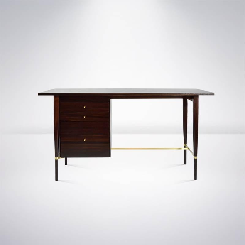 A freshly refinished desk designed by Paul McCobb, Calvin collection, circa 1950s. Signature brass stretchers newly polished.