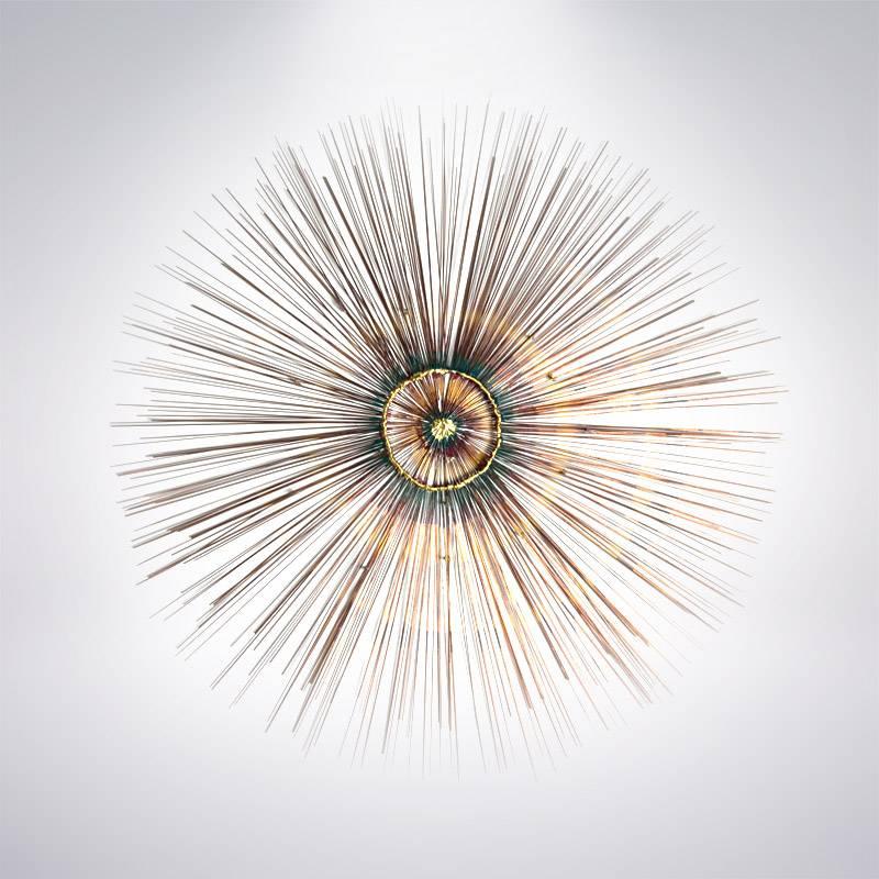 Large scale copper sunburst wall sculpture in the style of Curtis Jere, circa 1950s. Nicely executed all around with two layers of hundreds of copper rods, center is formed of irregularly melted copper in shades of green, gold and red.