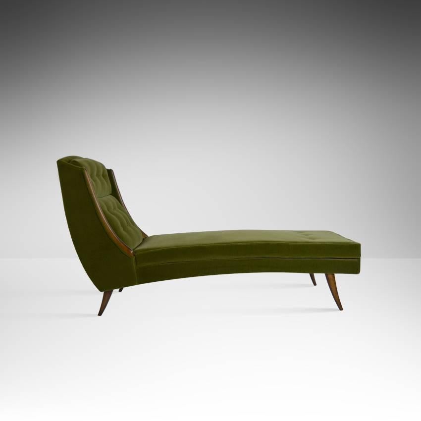 Rare chaise longue with sculptural lines, walnut trim and legs. Newly upholstered in green mohair.