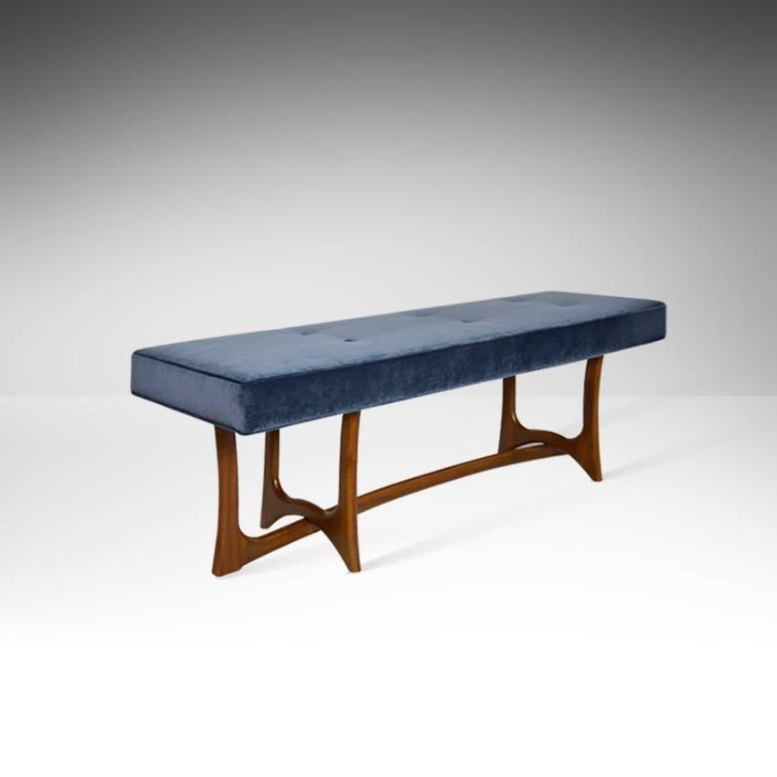 Sculpted newly refinished walnut bench by Adrian Pearsall for Craft Associates. Custom top upholstered in navy blue velvet.