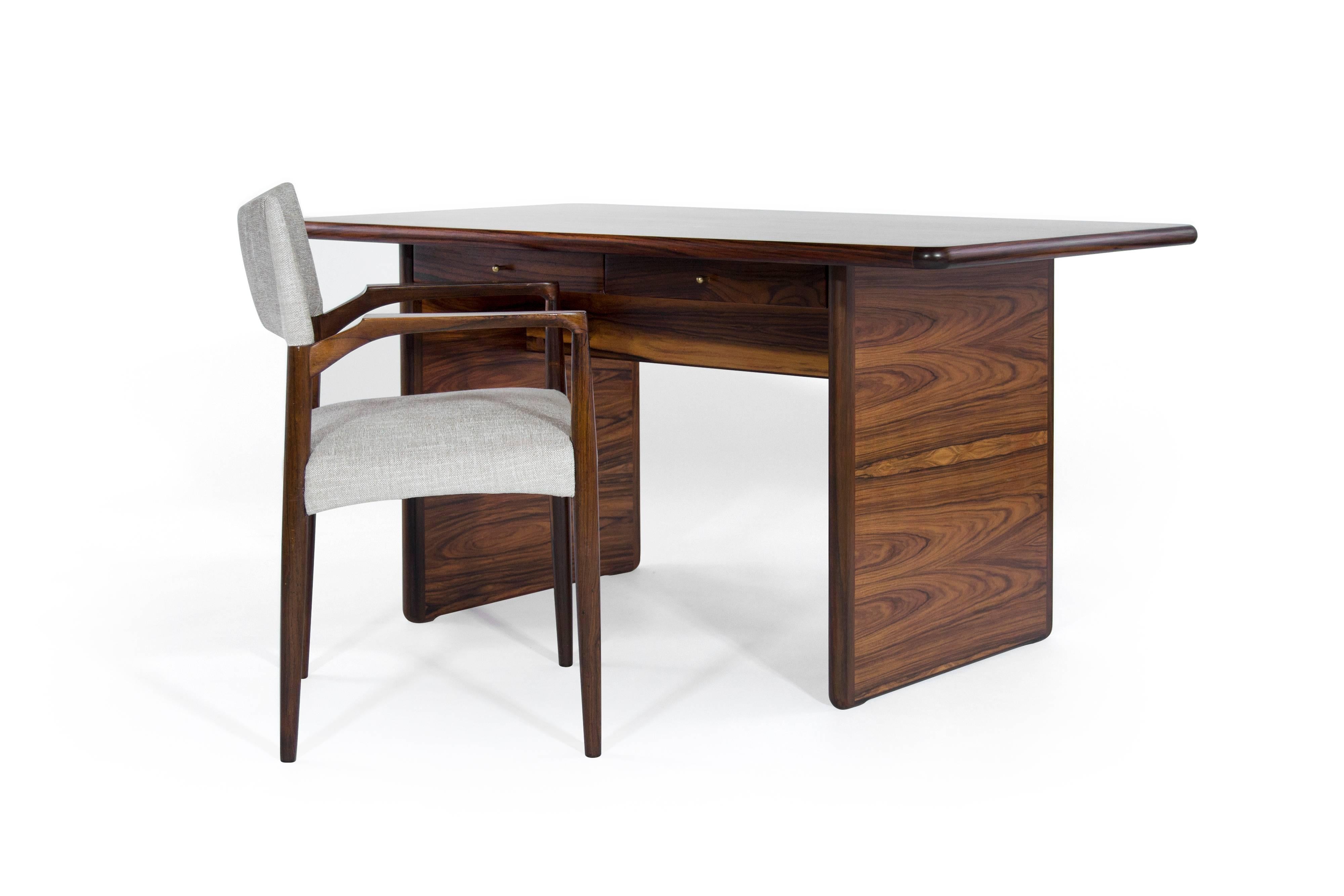 Gorgeous fully restored modern rosewood desk or writing table with twin drawers highlighted by brass pulls, Denmark 1960s.