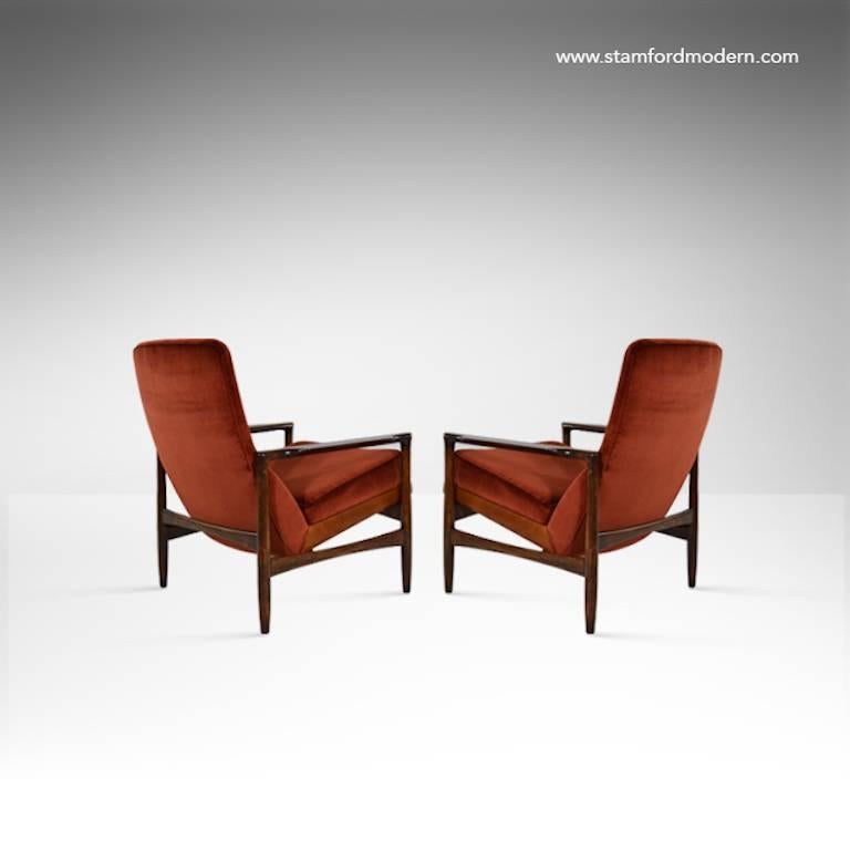 Rare pair of Danish modern lounge chairs designed by Torbjørn Afdal for Selig. This pair features a very distinct leather wrapped seat base. Wood fully restored. Newly recovered in velvet.