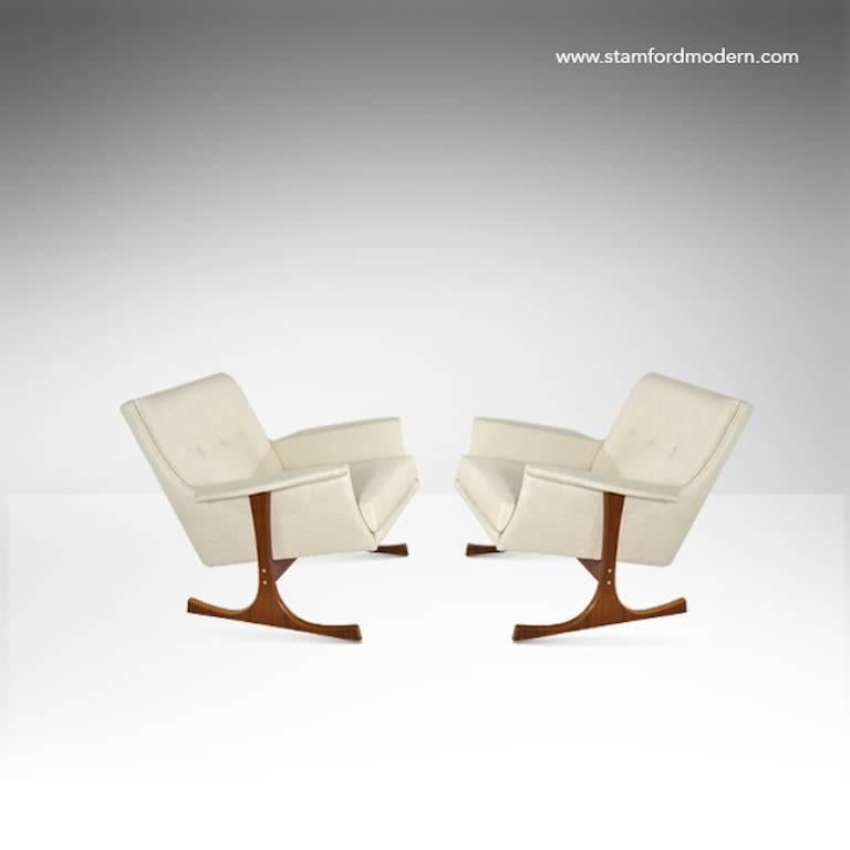 A great pair of Danish modern lounge chairs attributed to Ib Kofod-Larsen, manufactured by Selig. Teak framed in excellent vintage condition. Newly upholstered in beige linen.