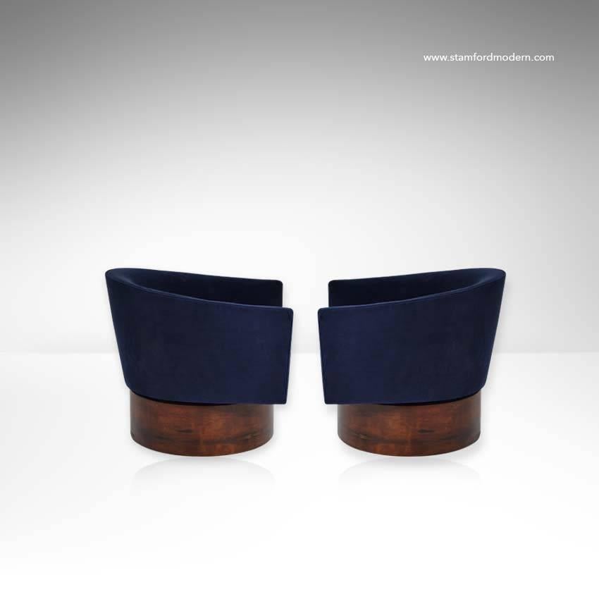 Very unusual pair of swivel chairs on high rosewood bases, designed by Milo Baughman for Thayer Coggin. Newly upholstered in navy blue velvet.