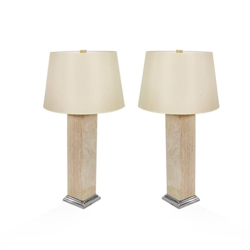 Fully restored pair of travertine table lamps in the style of T.H. Robsjohn-Gibbings. Travertine in excellent vintage condition, chrome stands newly polished. Both fully rewired.