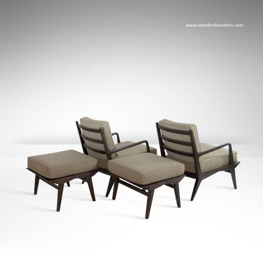 Pair of sculptural lounge chairs and ottomans with frames in dark walnut by Carlo di Carli for M. Singer & Sons, American, 1950s. Newly refinished and reupholstered.

Ottomans dimensions: Width 24.5