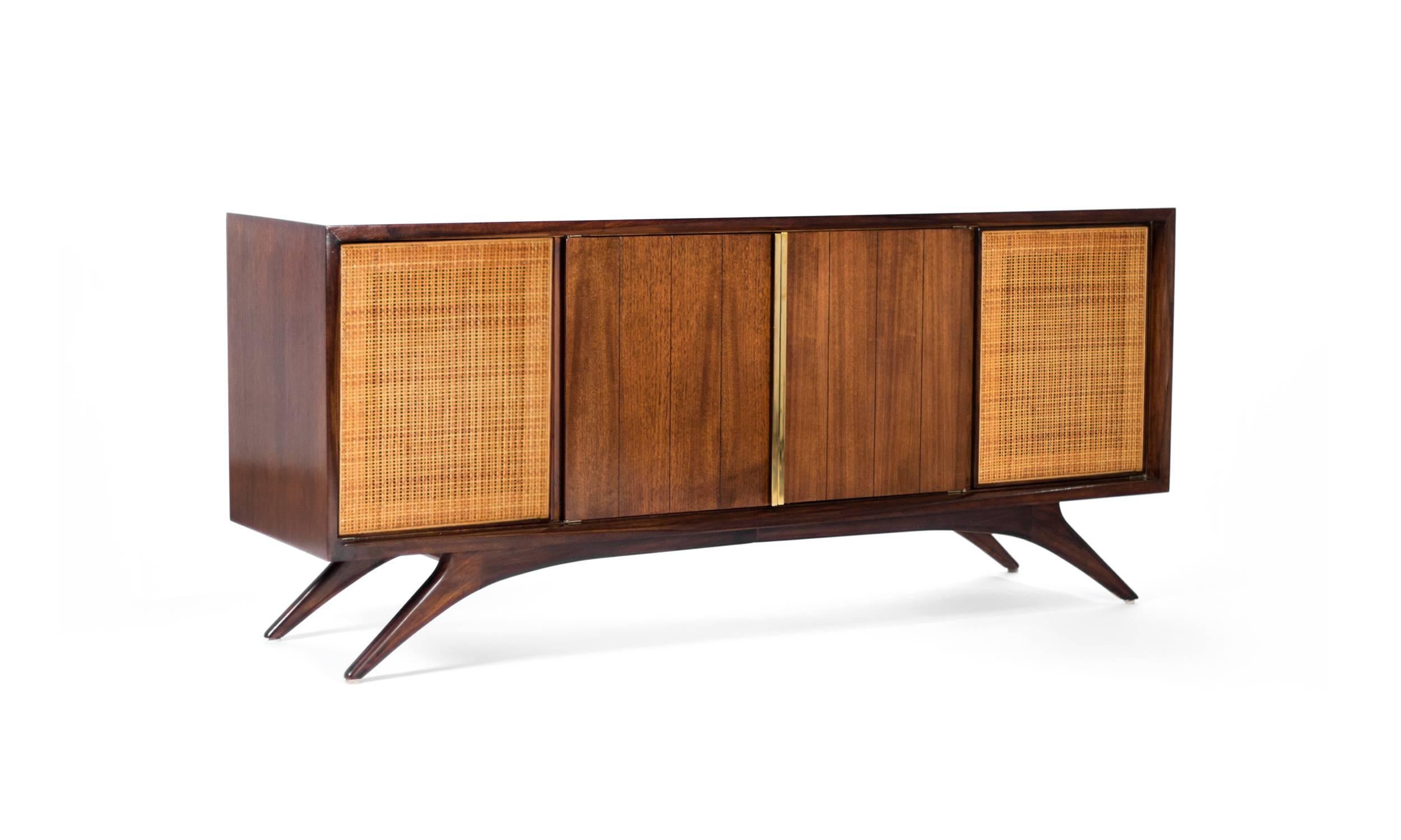 A fully restored credenza or sideboard designed by Vladimir Kagan for Grosfeld House, New York, circa 1950s. Original cane panels in mint condition.