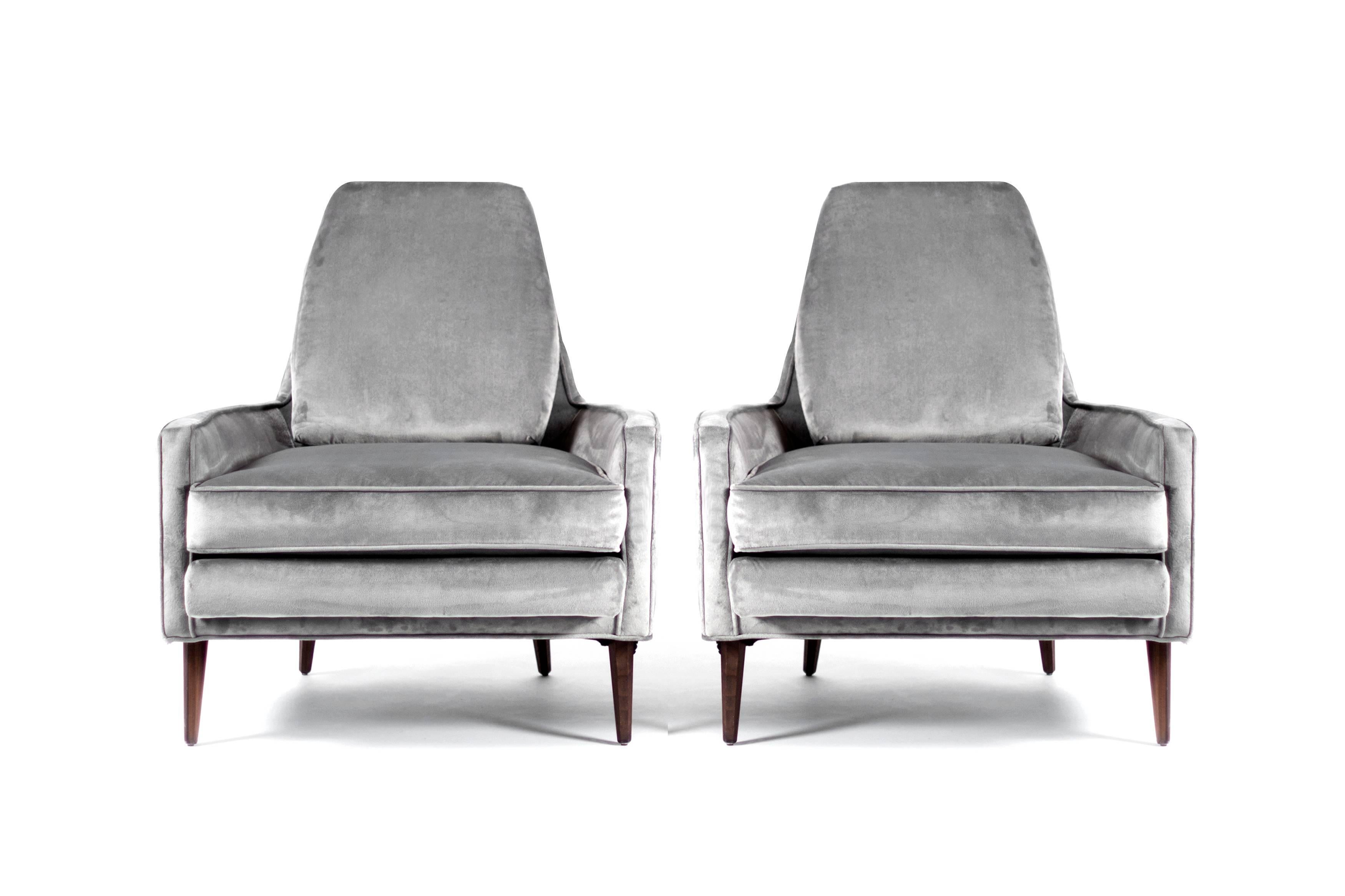 Pair of lounge chairs in the manner of Paul McCobb, newly upholstered in grey velvet.