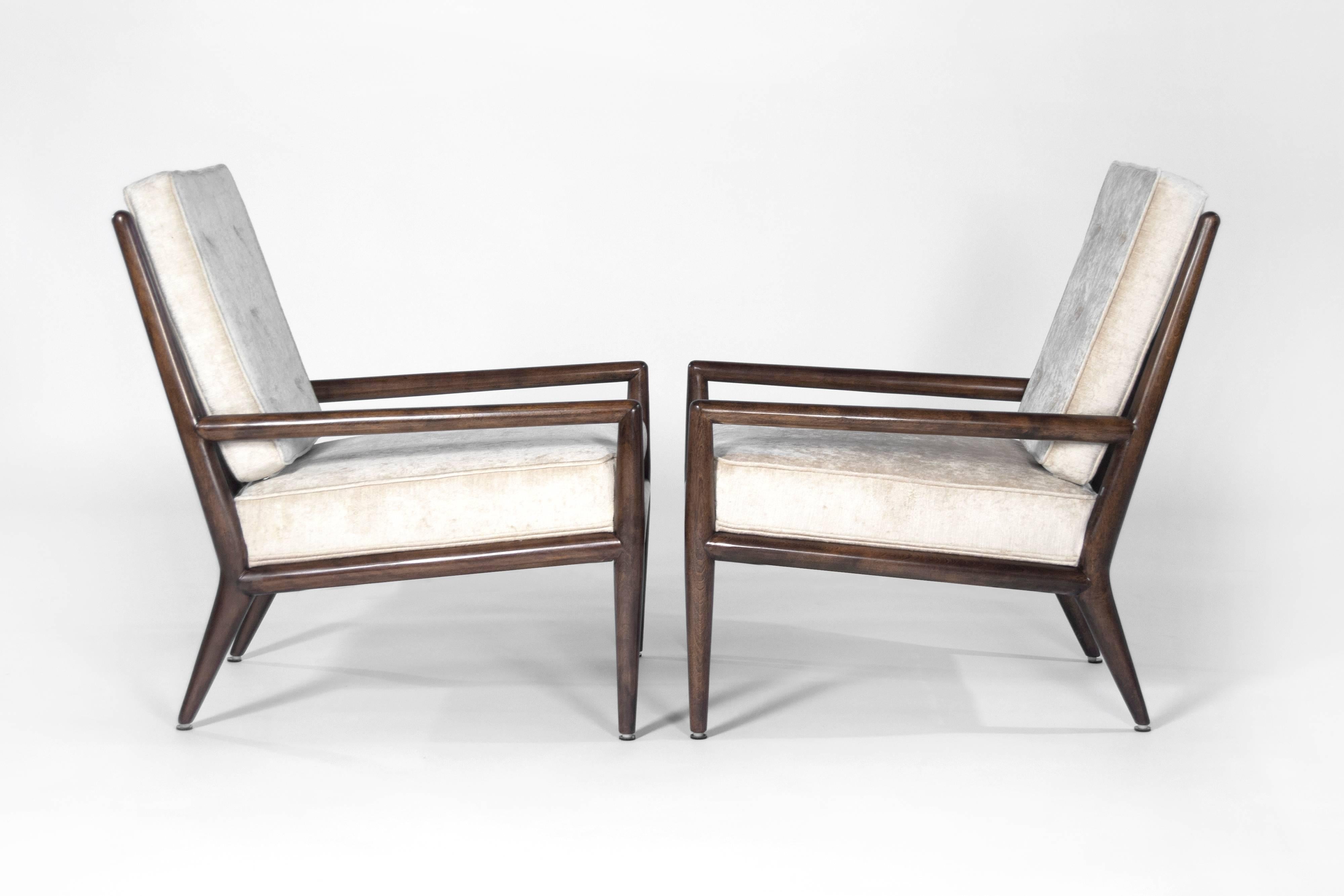 Lovely pair of Classic lounge chairs by T.H. Robsjohn-Gibbings for Widdicomb. Walnut fully restored. Re-upholstered in a very subtle beige chenille.