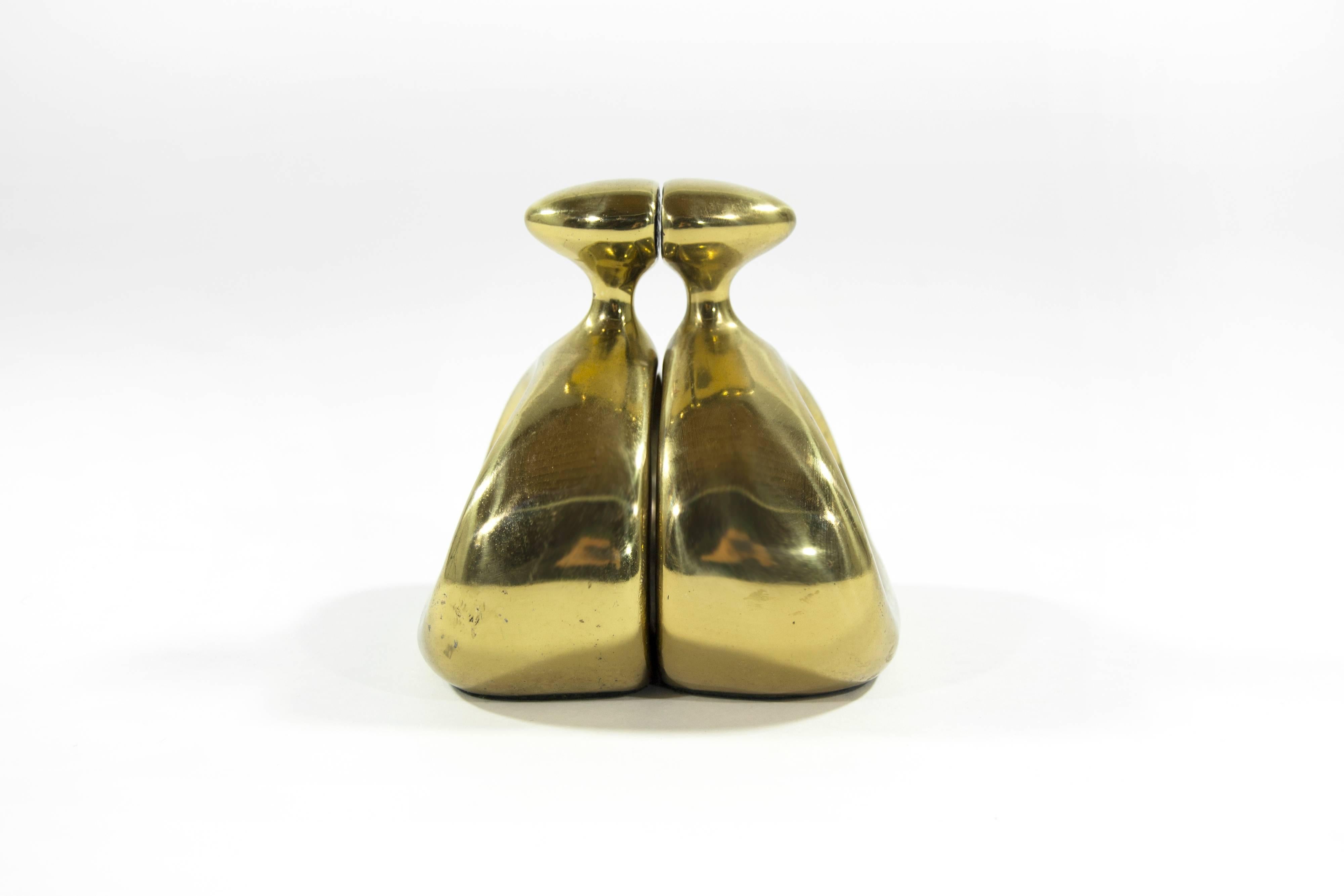Sculptural pair of bronze bookends in a rounded triangle form with bullet like finials, an open sculptured body with a flared base. By Ben Seibel for Jenfred Ware, American, circa 1950.