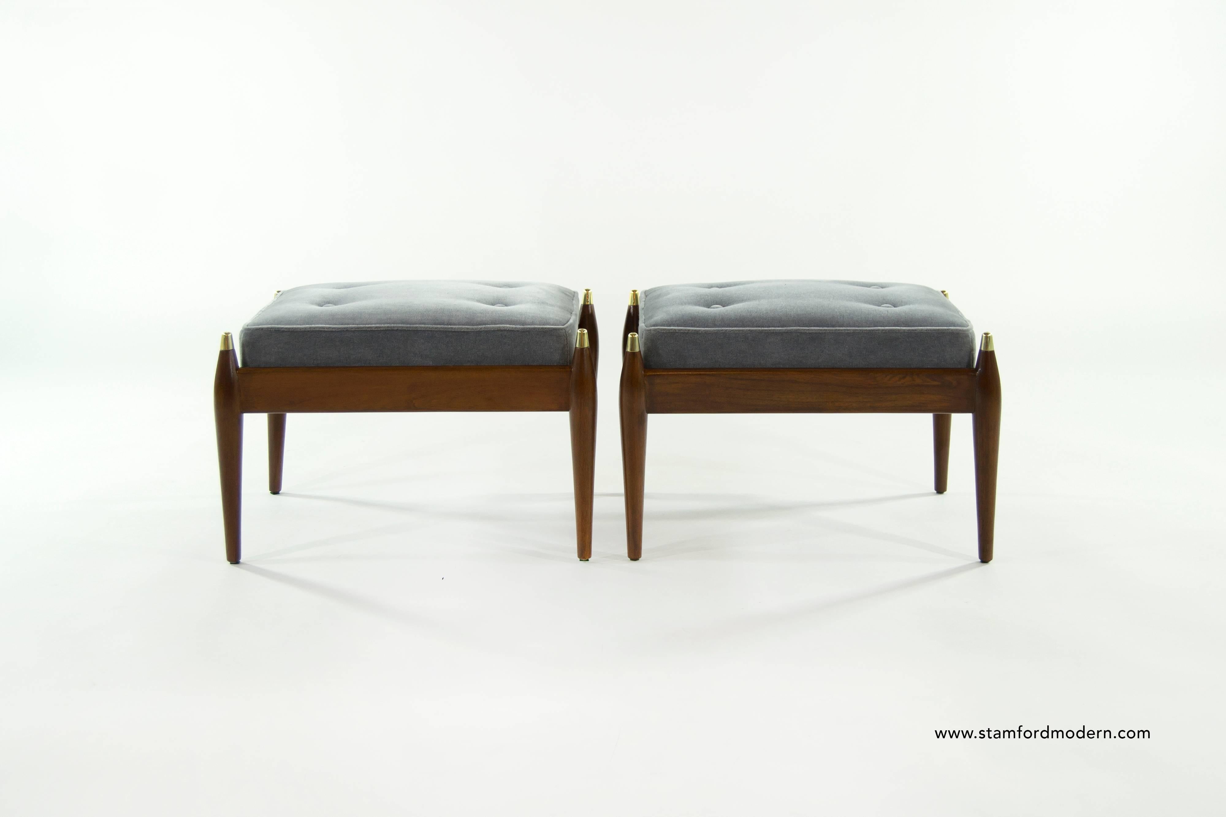 Pair of teak stools with brass details, newly upholstered in mohair.