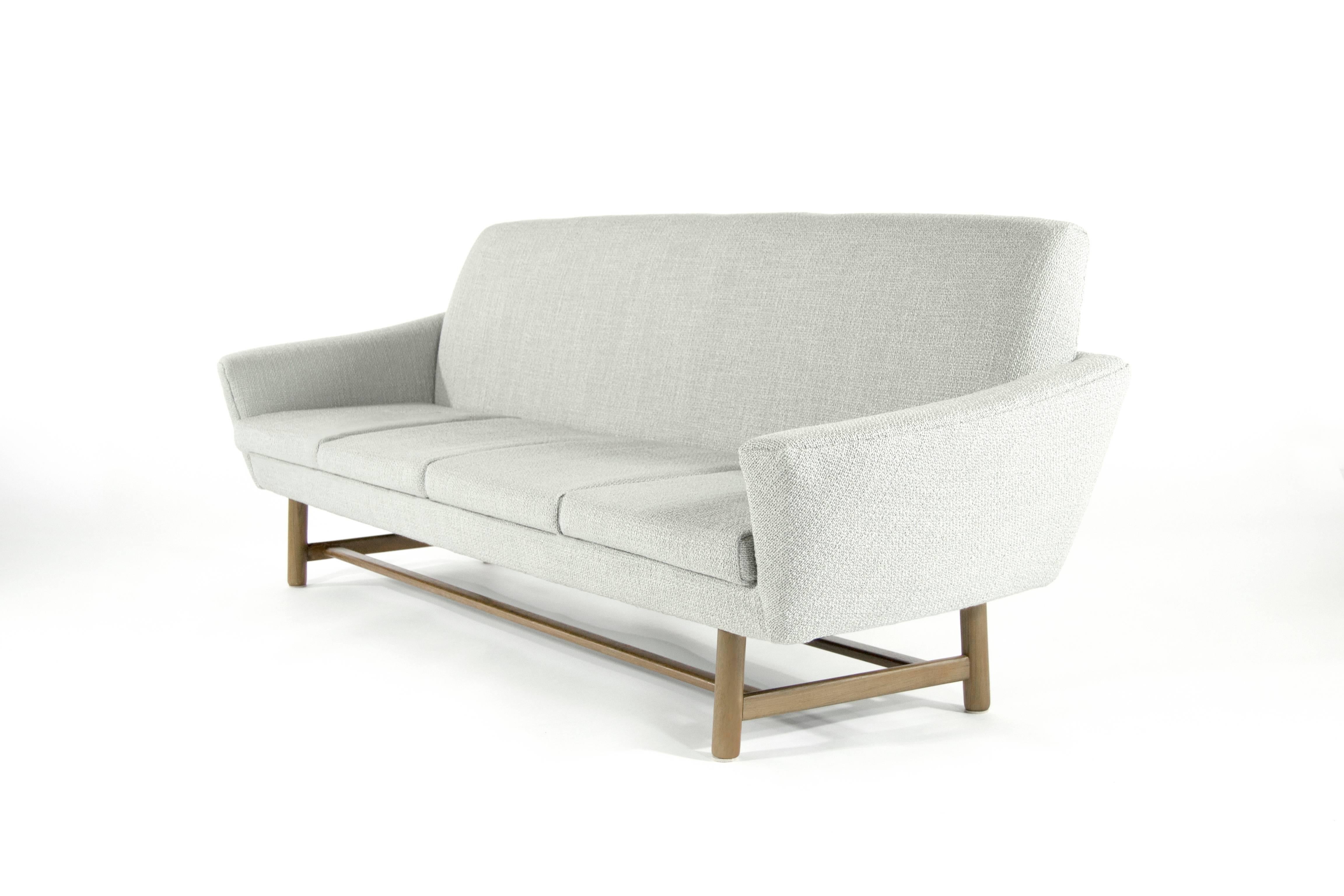 Danish Modern floating sofa, newly upholstered in grey tweed. Sculptural teak base fully restored.