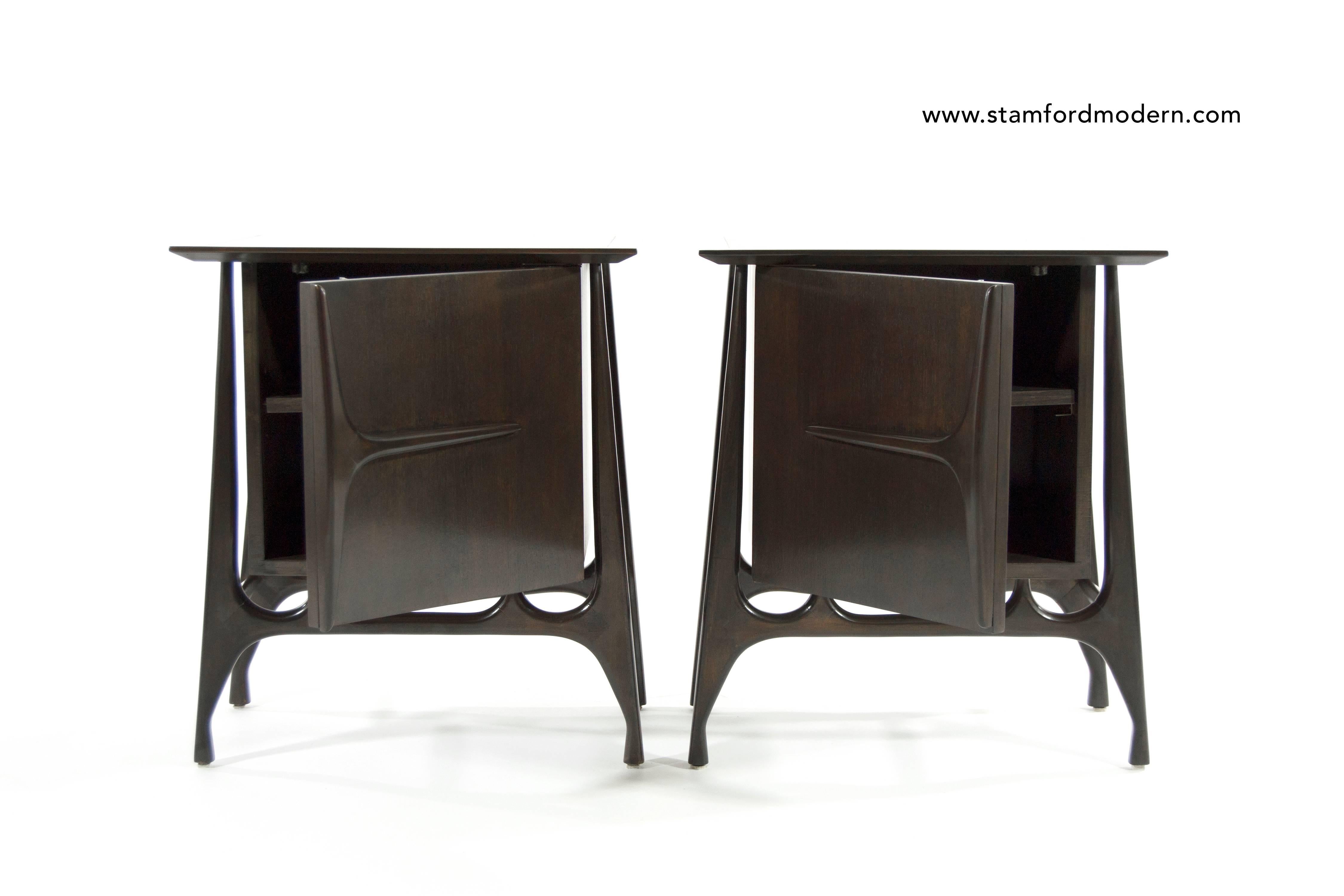 A great pair of end tables or nightstands featuring sculptural form. Newly refinished in dark walnut.