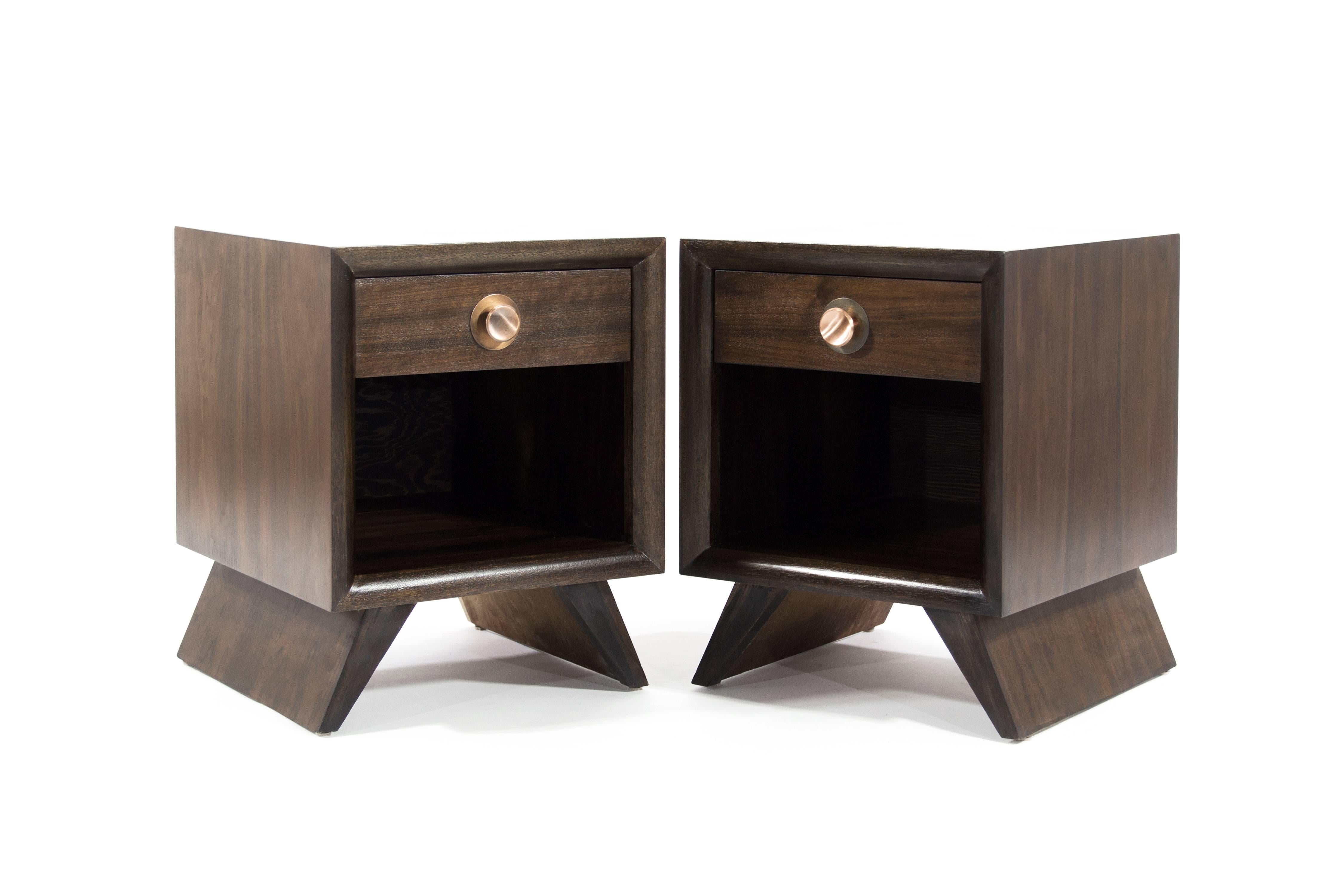 Exquisite pair of Mid-Century Modern walnut end tables in the style of Paul Frankl, circa 1950s. Fully restored to their natural walnut tone, single drawer features patinated copper hardware.