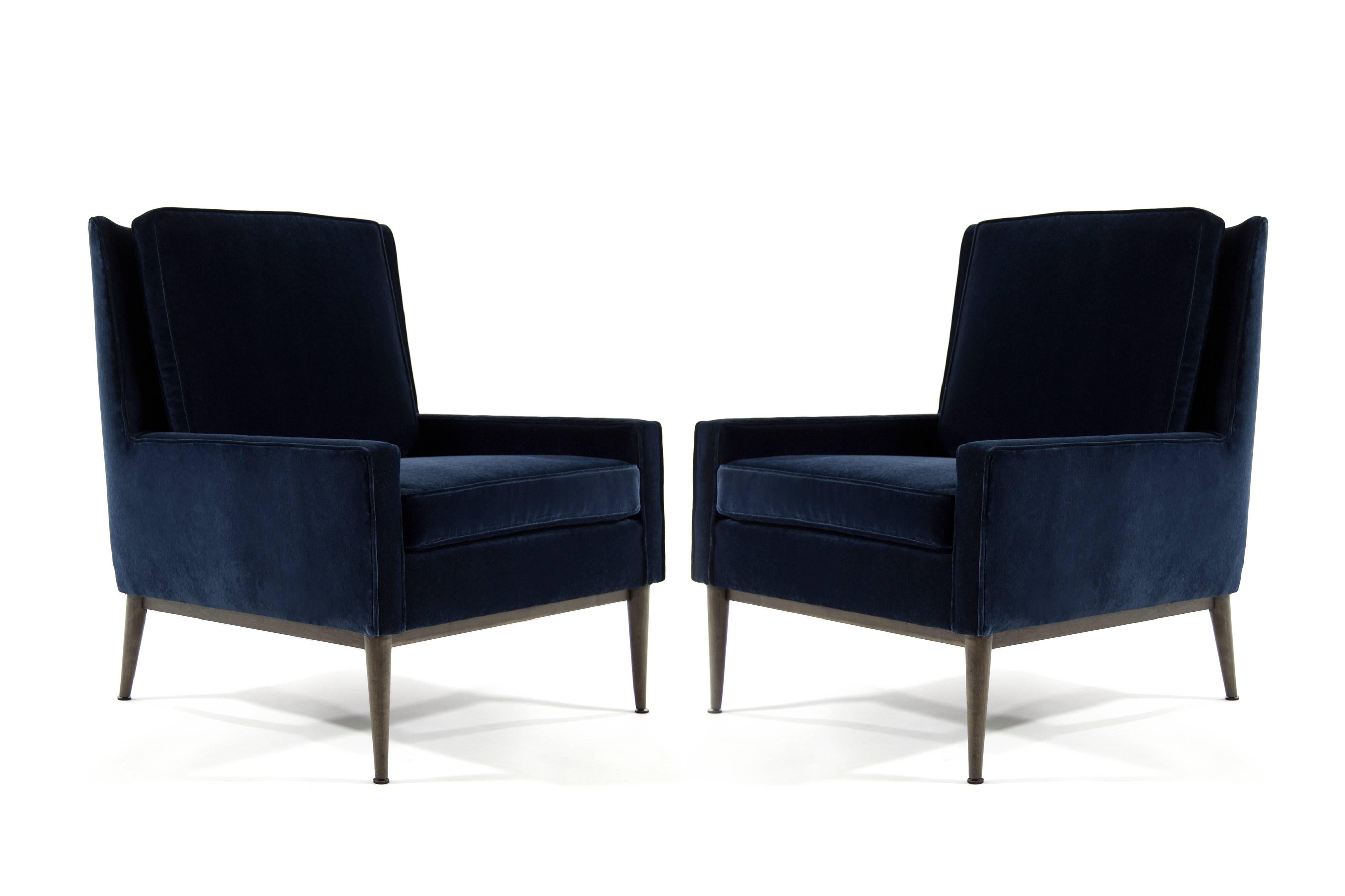 Pair of Classic lounge chairs designed by Paul McCobb for Directional, model 1312, circa 1950s. 

Walnut bases full restored. Newly recovered in fabulous JB Martin navy blue velvet.