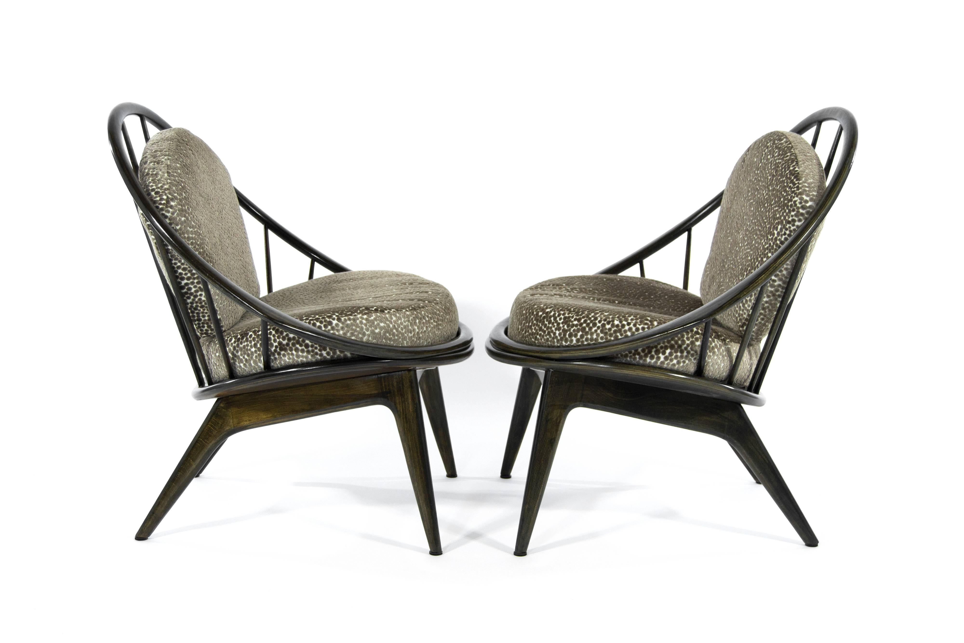 Rare pair of lounge chairs denominated "The Hoop Chairs" by Ib Kofod-Larsen for Selig, Denmark, circa 1959.

Walnut frames fully restored. New cushions upholstered in a polka dot embossed velvet.