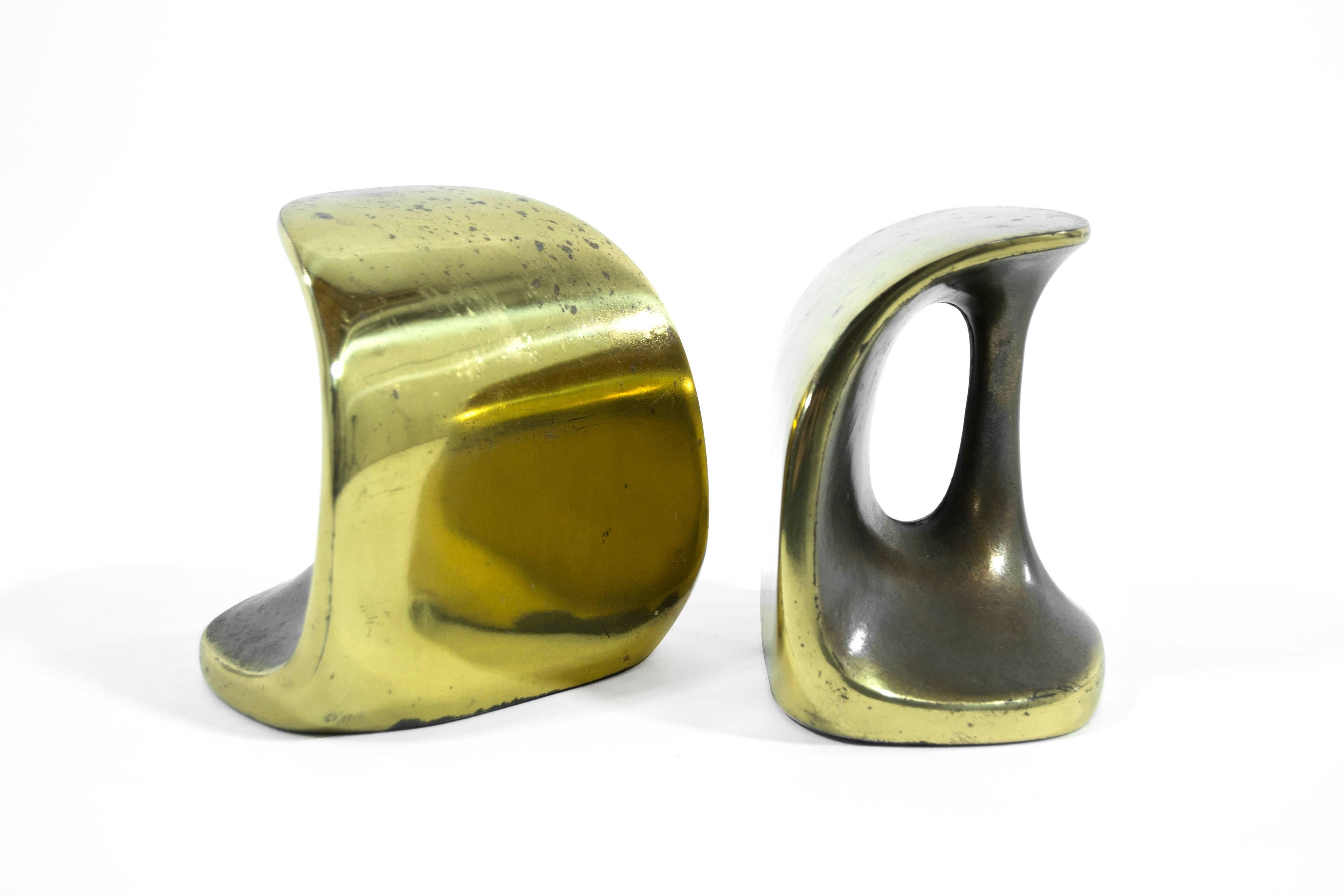 Pair of sculptural cast brass bookends with handles by Ben Seibel for Jenfred Ware and distributed by Raymor. They retain their original felt bottoms and label.