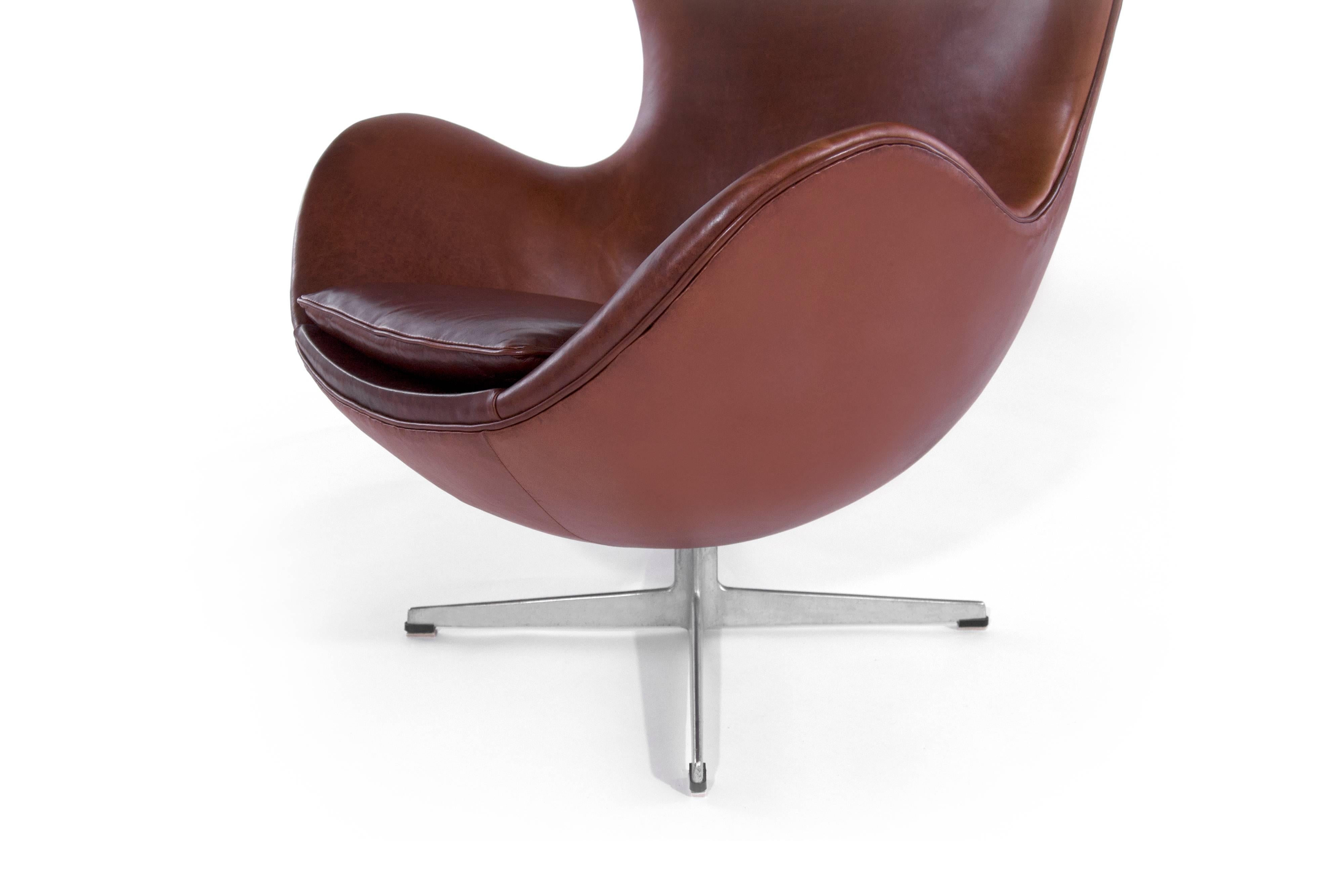 The Iconic Egg Chair, model 3316 and matching footstool model 3127, designed by Arne Jacobsen. Produced by Fritz Hansen in Denmark, 1965. Newly upholstered in chianti leather. Single chair and footstool available.

