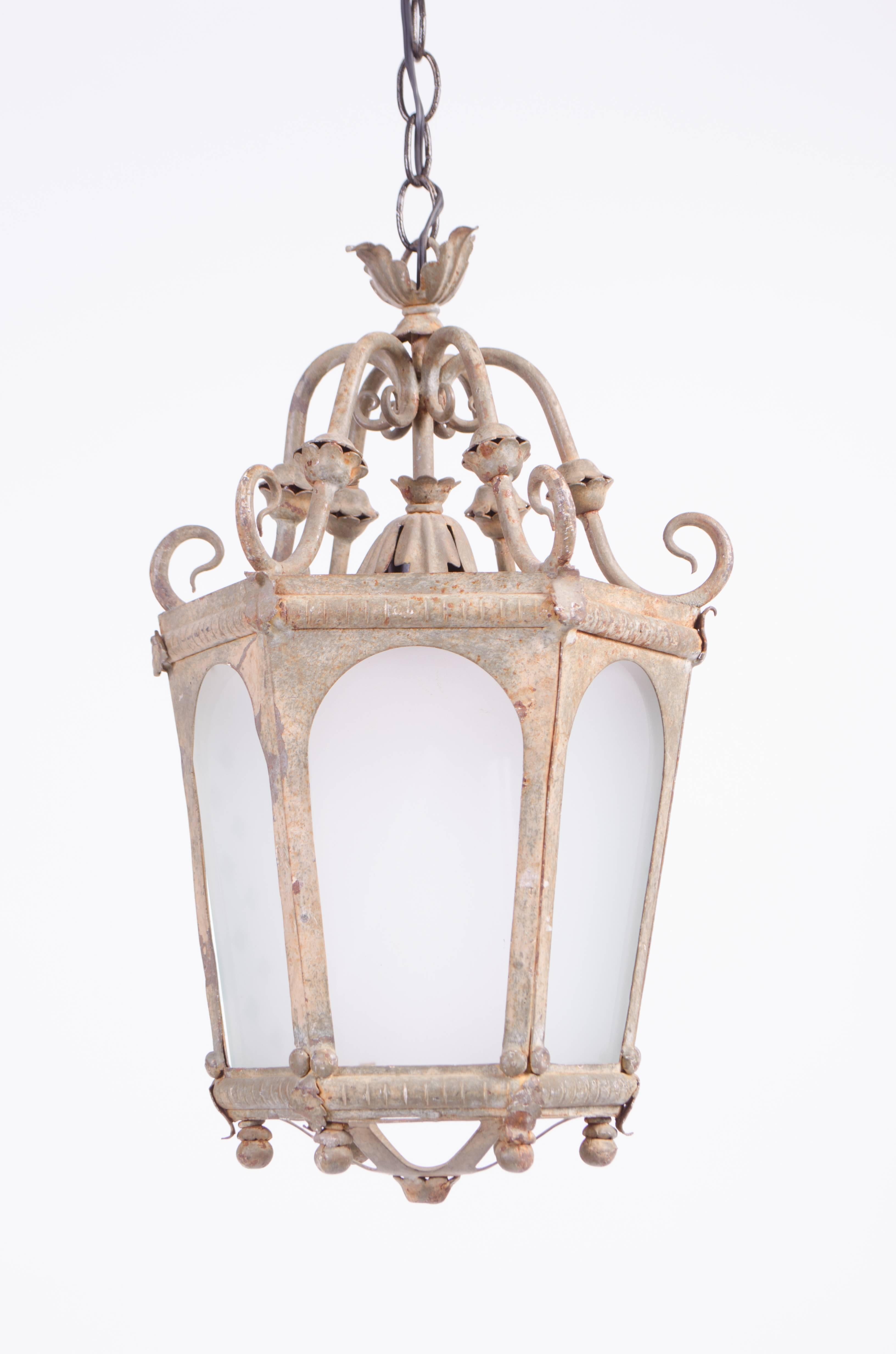 A pair of fabulously patinated French hanging lanterns with excellent detailing and ornamentation. All metalwork is intact, astonishing for pieces of this age. these have been re-wired for modern day usage, adding a certain level of French charm