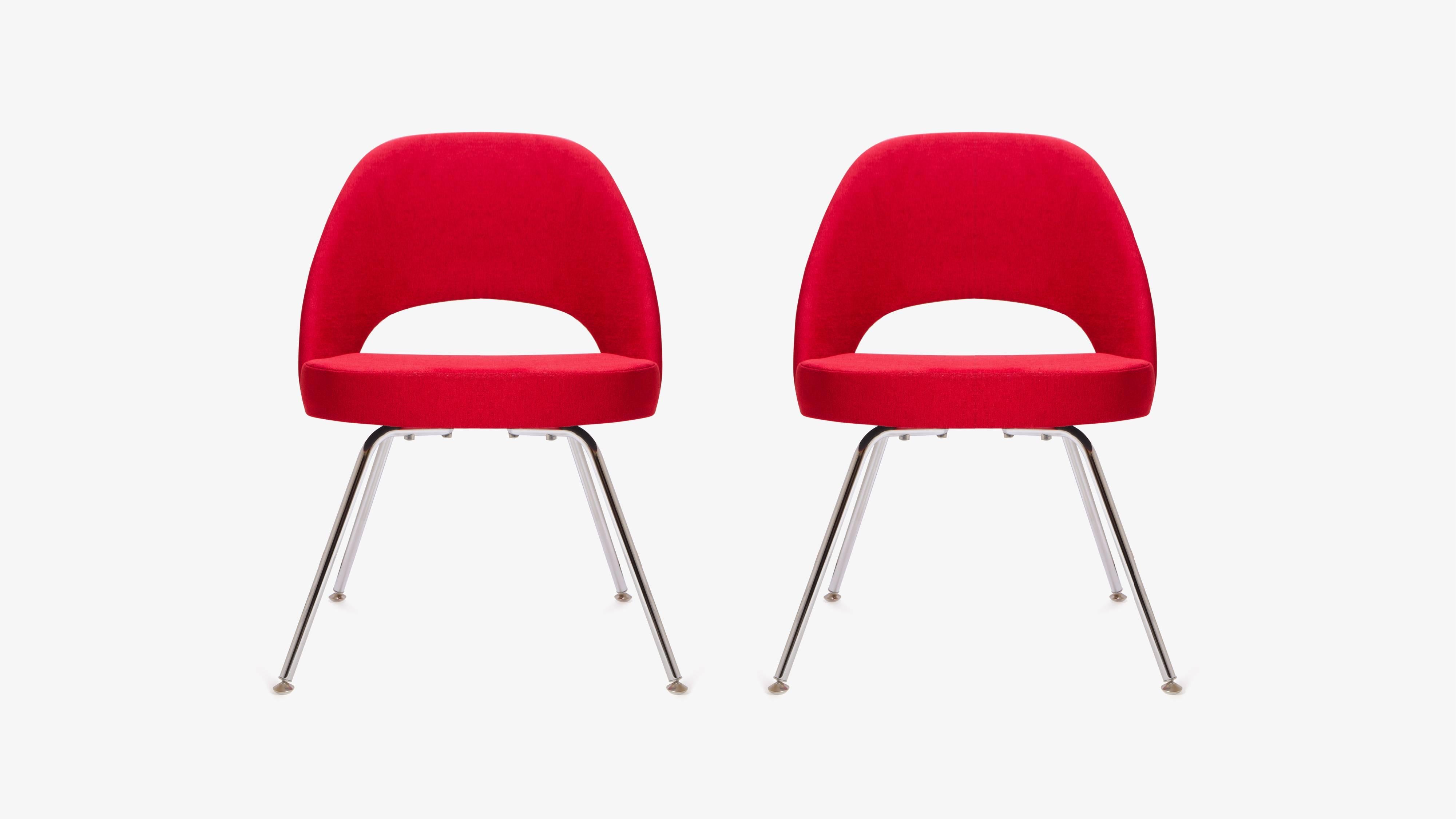 Mid-Century Classic Eero Saarinen executive armless chairs, manufactured by Knoll Furniture. These are upholstered in an original knoll textile fire-red fabric. Literally in brand new condition, foam on the seat and back maintain original shape and