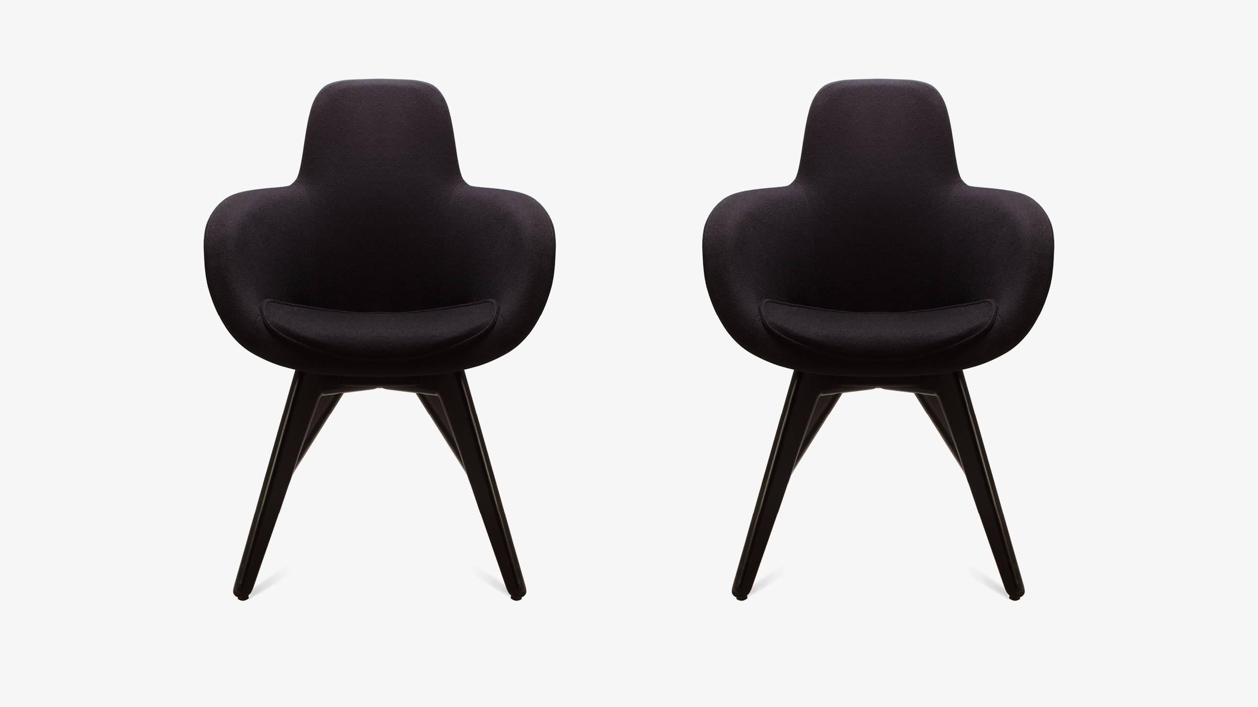 Tom Dixon is a master in marrying organic and geometric design, ringing true with his Scoop chair series. These chairs combine a fluid upholstered top with an architectural four-leg wood base. The tops are crafted from injection molded foam that is