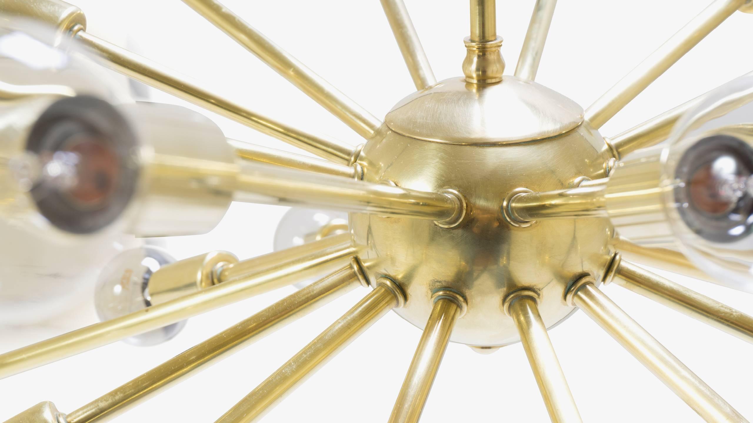 A wonderfully restored "Sputnik" pendant chandelier is the quintessential item that any collector of the Mid-Century needs in their home. This piece features 28-bulb lamping supported by its polished brass body. The brass is in excellent