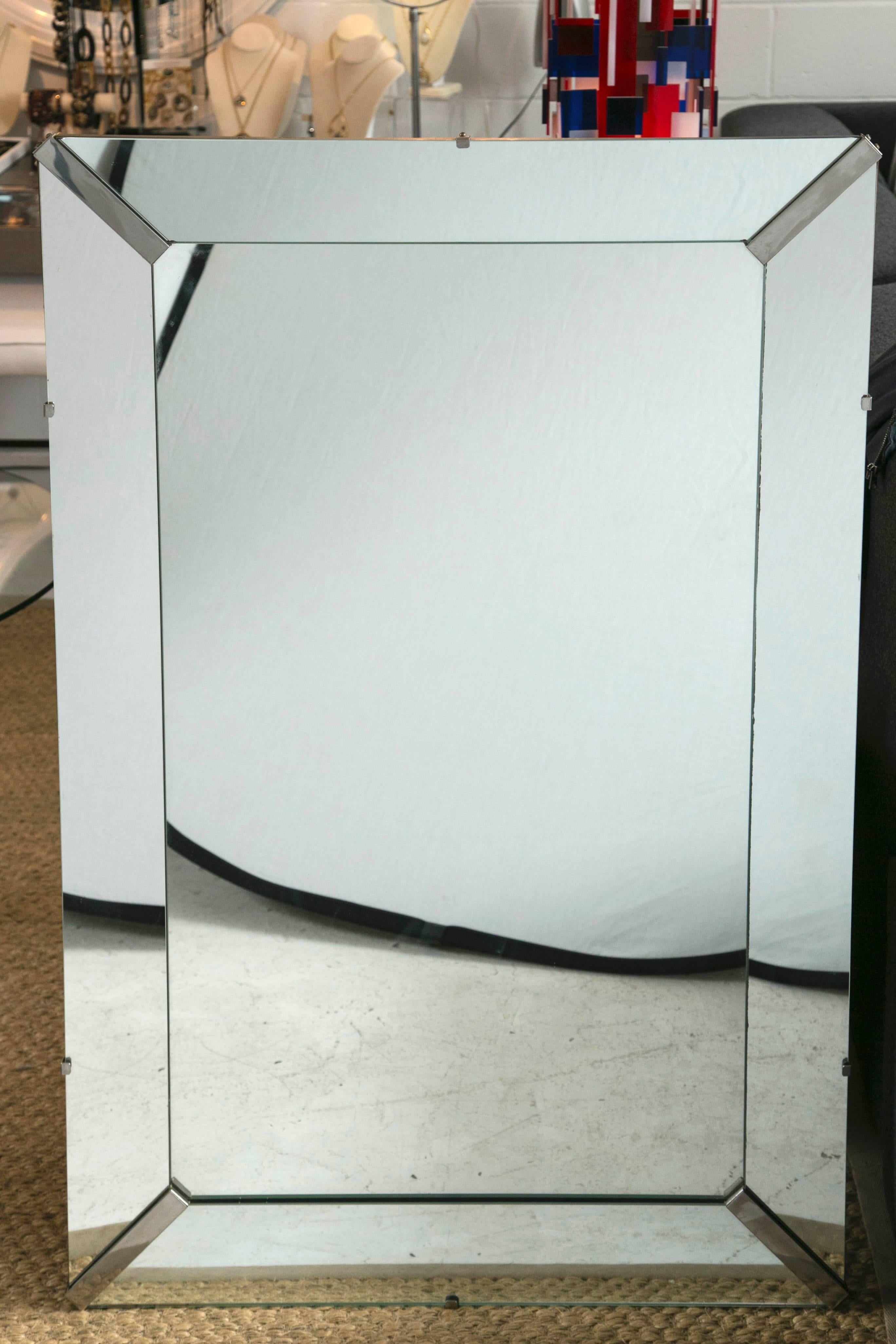 Large heavyweight rectangular mirror framed with mirror as well. Stunning piece accented with chrome at each corner. Ready to hang in both portrait and landscape positions. Two D-hooks for portrait and wired for landscape. Great quality and