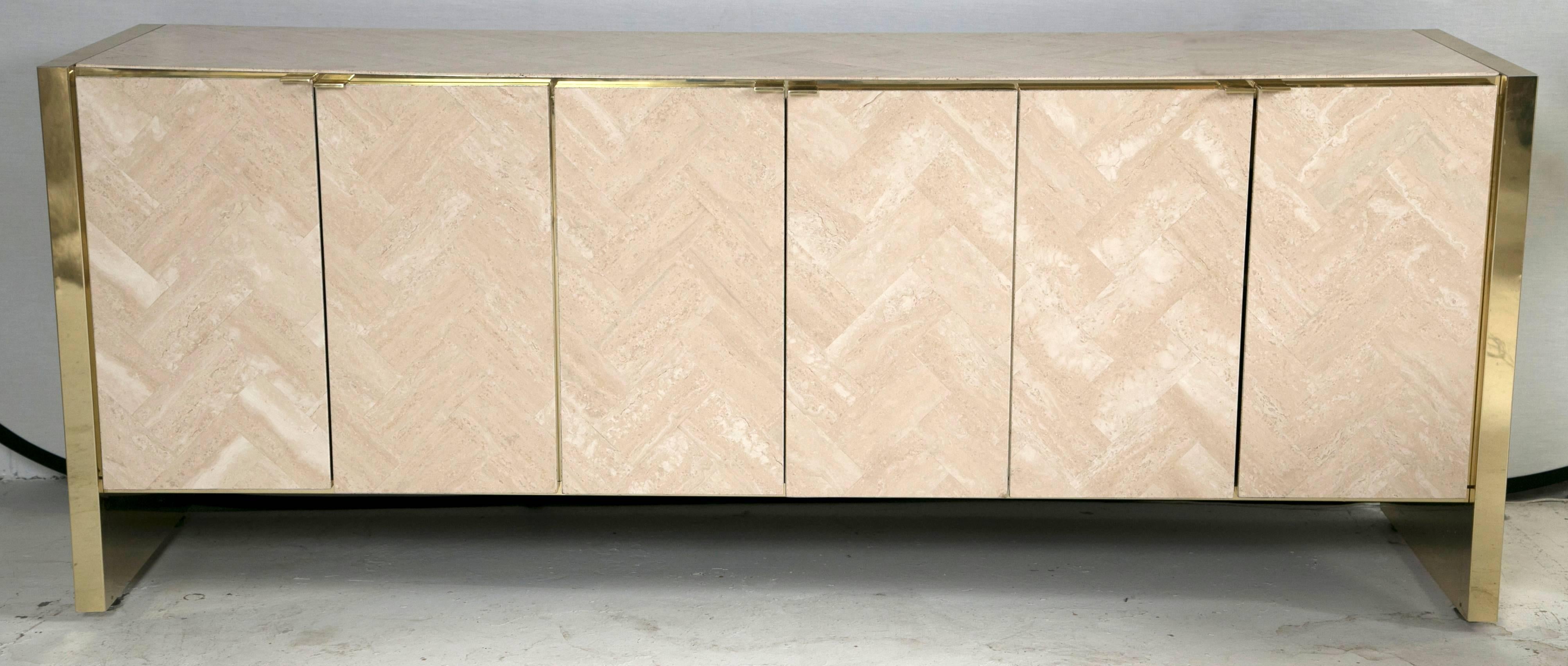 A piece that is as elegant as it is powerful. Designed by Ello Furniture, it has three cabinets, two of which have built in drawers. The faces of each door are designed with highly polished herringboned travertine. The piece is then trimmed with
