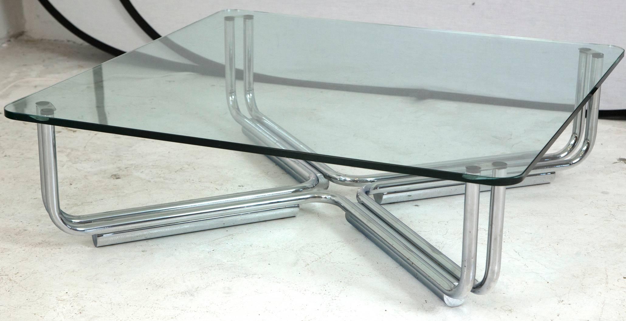 A stunning example of Italian craftsmanship and design. Gianfranco Frattini for Cassina coffee table (Model 784), designed with a tubular chrome frame and a custom piece of rounded corner class. The piece sits with grace as it is low to the ground.