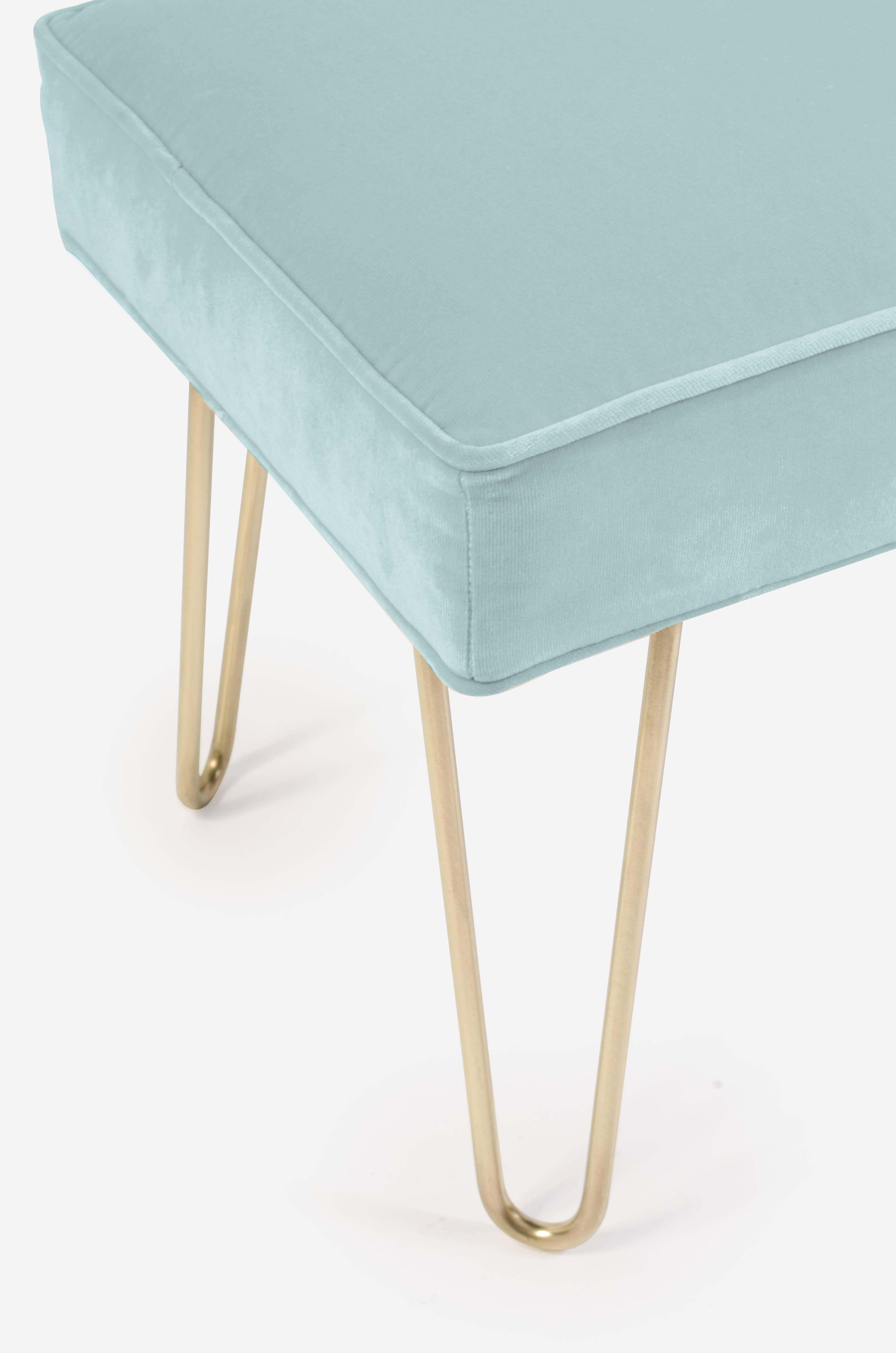 The perfect addition to any space! Wonderfully proportioned pair of ottomans upholstered in a supple mint velvet of the highest quality; 100% cotton. This work in a multitude of spaces: In a living space, under a console, at the foot of a bed. Think