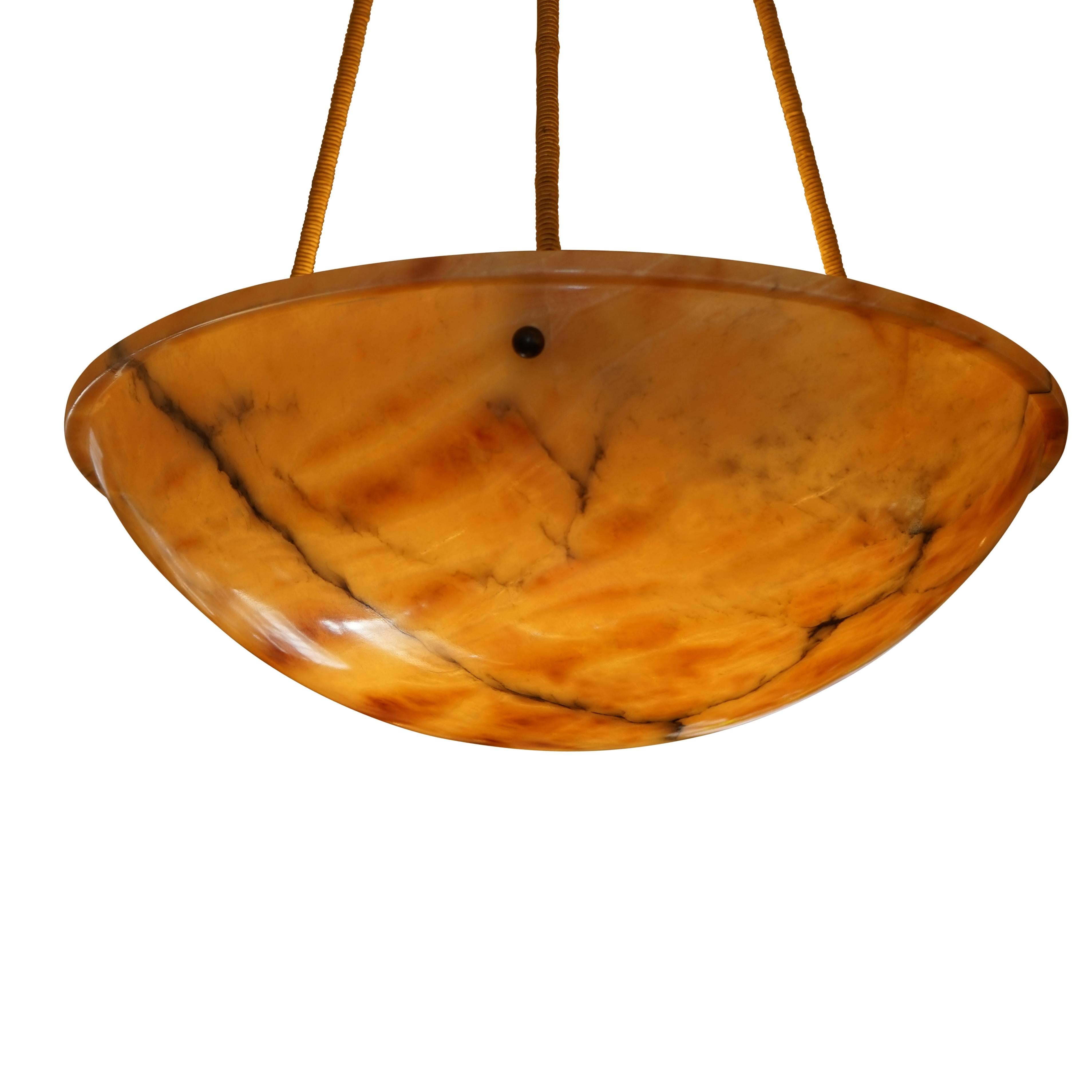 Carved from unusual, veined, multi-toned alabaster, with a matching alabaster canopy, the light has been recently rewired, and holds three 40 watt incandescent bulbs, to here LED bulbs of any wattage.