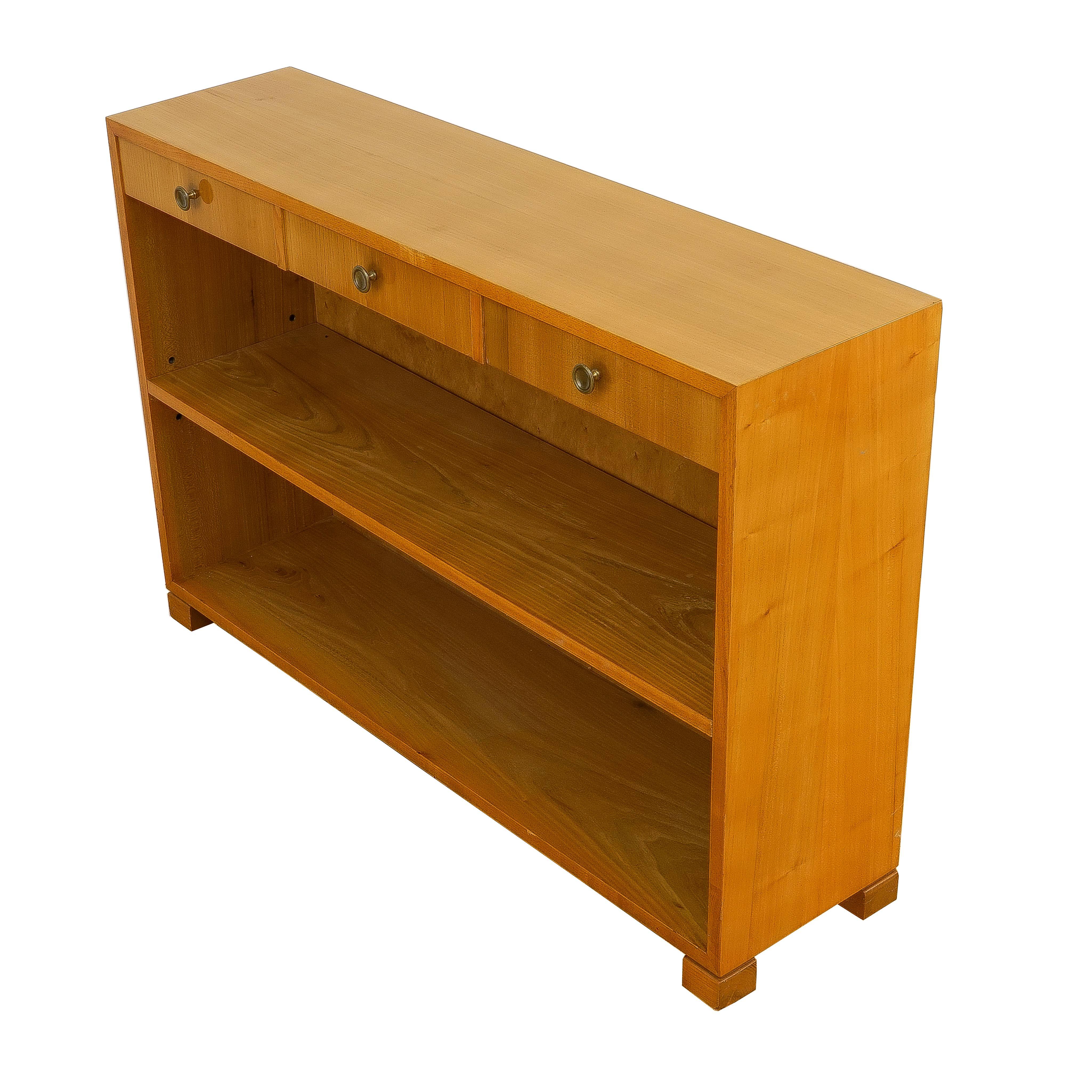 Functional and space efficient, this console performs many duties, storing books and gloves, check book and keys, photo display for a hall, or as serving space for a small kitchen or dining area. Crafted of solid ash and fir, the console is