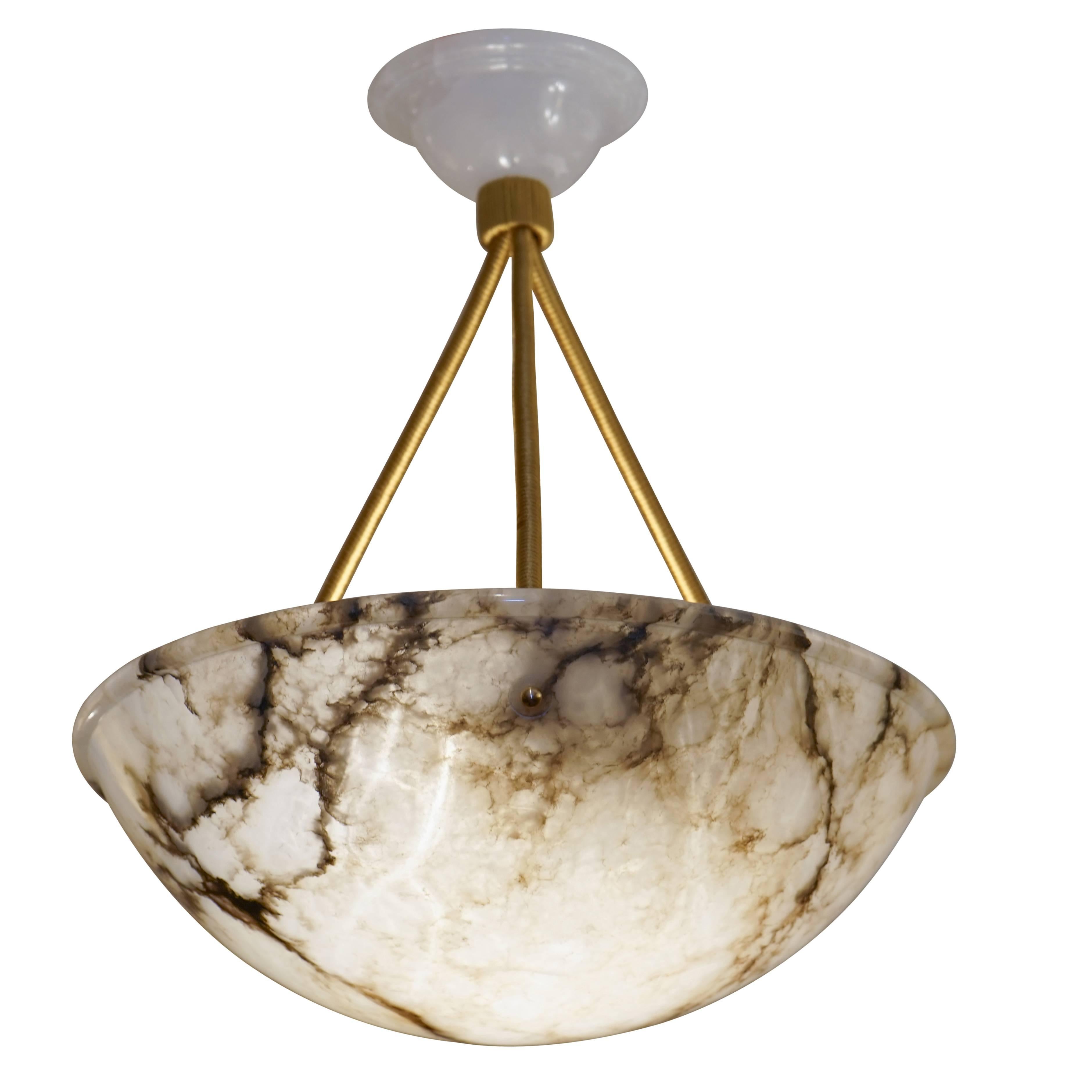 A pristine piece, with delightful transparency due to the high crystal content in the alabaster! Distinct charcoal mineral veining offers dramatic interest to this wonderful fixture. Recently rewired, the piece holds three 40 watt incandescent