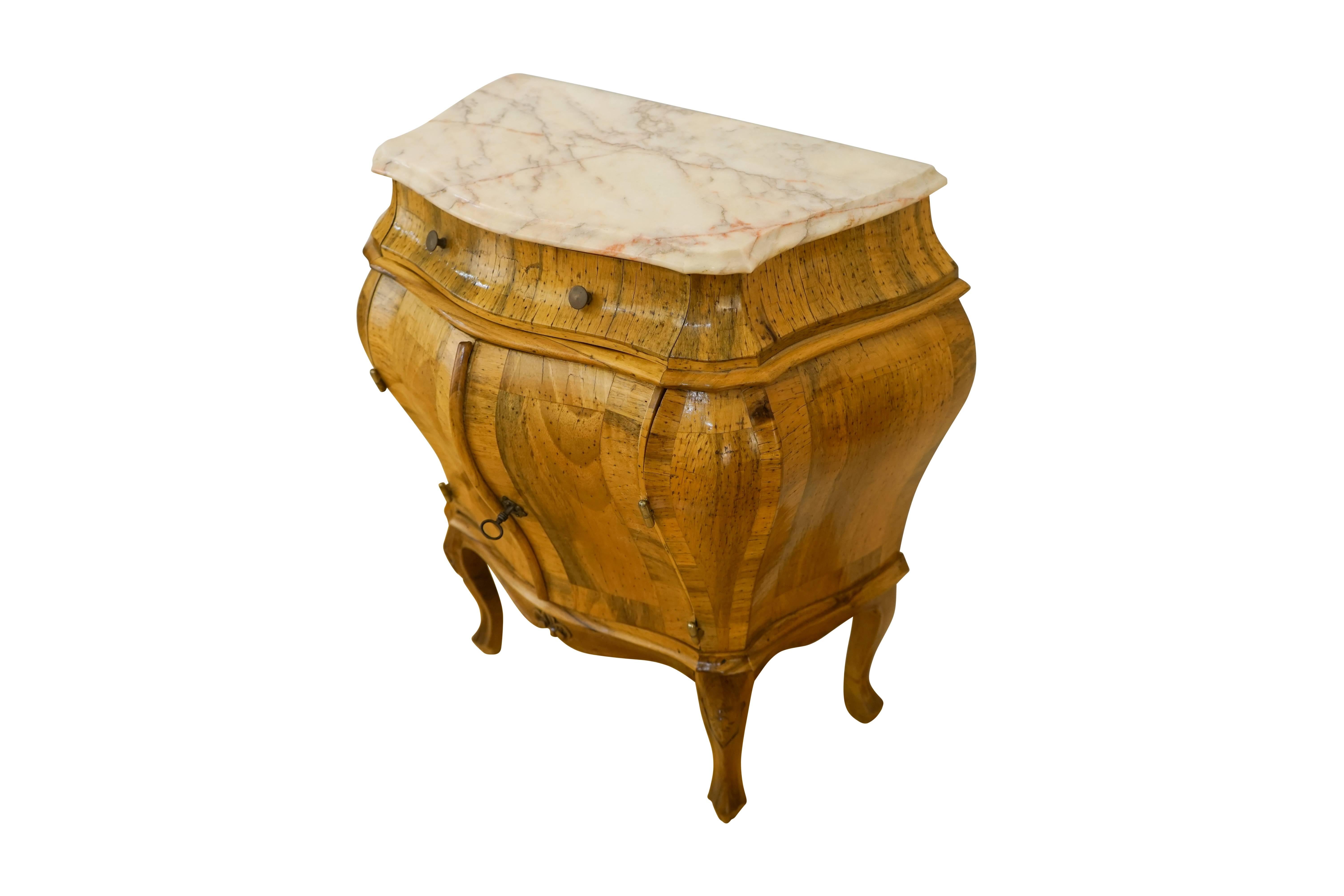 Beautiful and functional, these bombé chests with articulated marble tops offer copious interior storage, with one deep, upper drawer and a lower compartment divided by a solid wooden shelf. Crafted of solid wood, and veneered with exotic