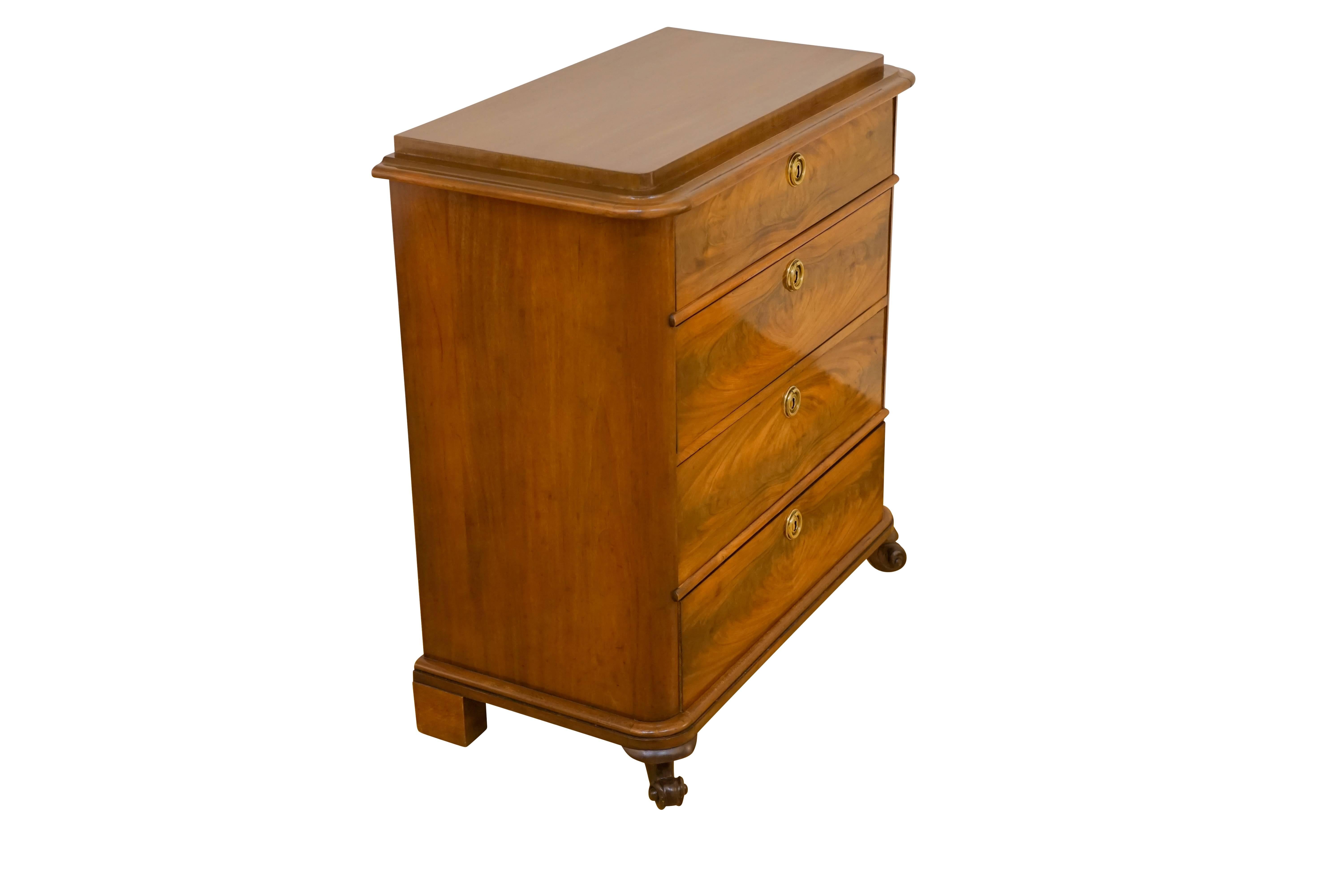 Classically designed, and crafted of solid mahogany, fir and flame mahogany veneers, the chest offers four locking drawers, with original escutcheons and key. Block feet about the wall, while curved and decorative feet face the world!