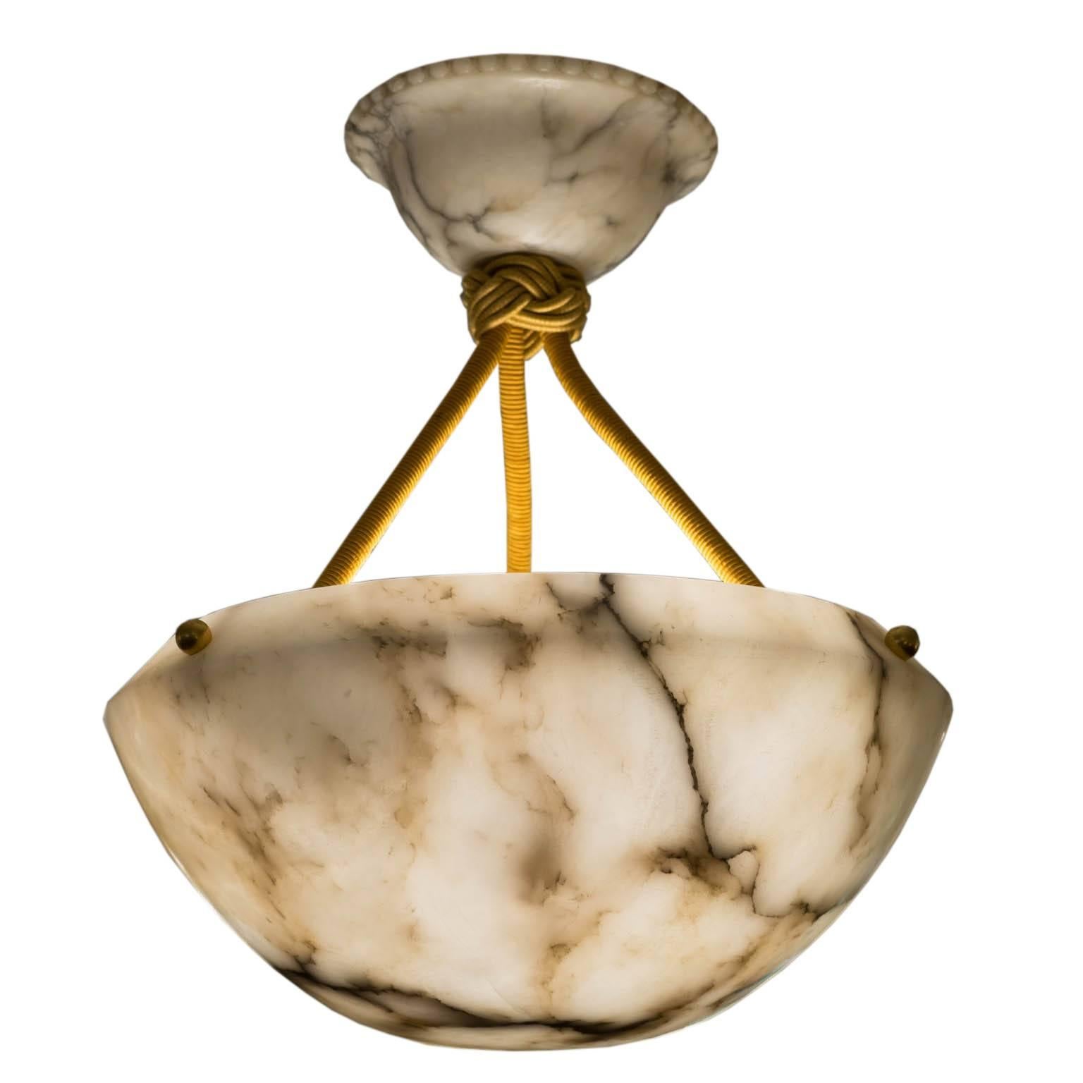 Such a fascinating fixture for a small space! Visually intriguing from every angle, the moody, charcoal mineral veining is mirrored in its matching canopy. The deep amulet shape lends itself to staircases or settings where the bulb may otherwise be