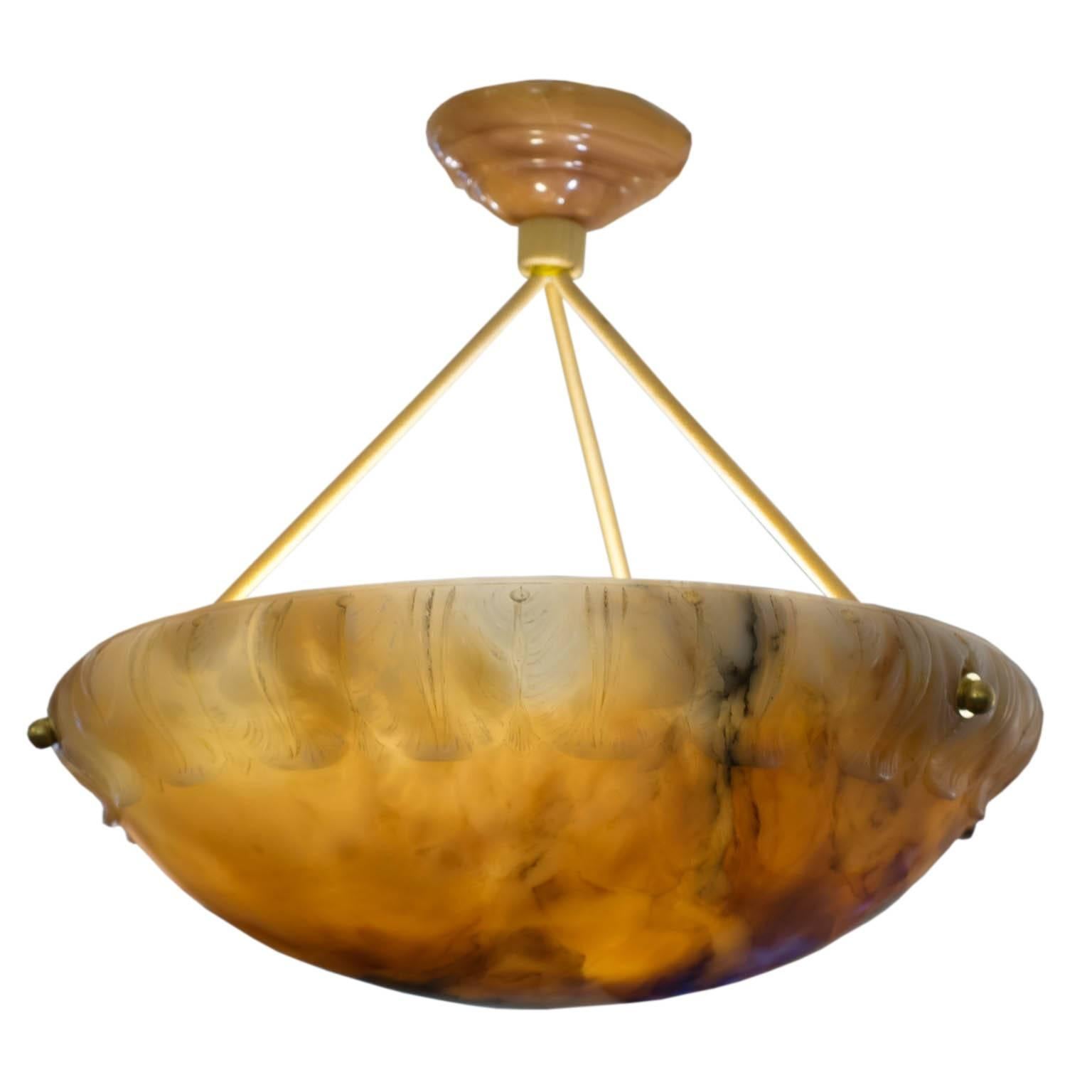 Visually exciting, this pendant was carved for a nineteenth century home being retrofitted for electricity. The mineral rich stone compliments the acanthus leaf motif adorning the upper edge. The fixture is suspended from a ceiling canopy of