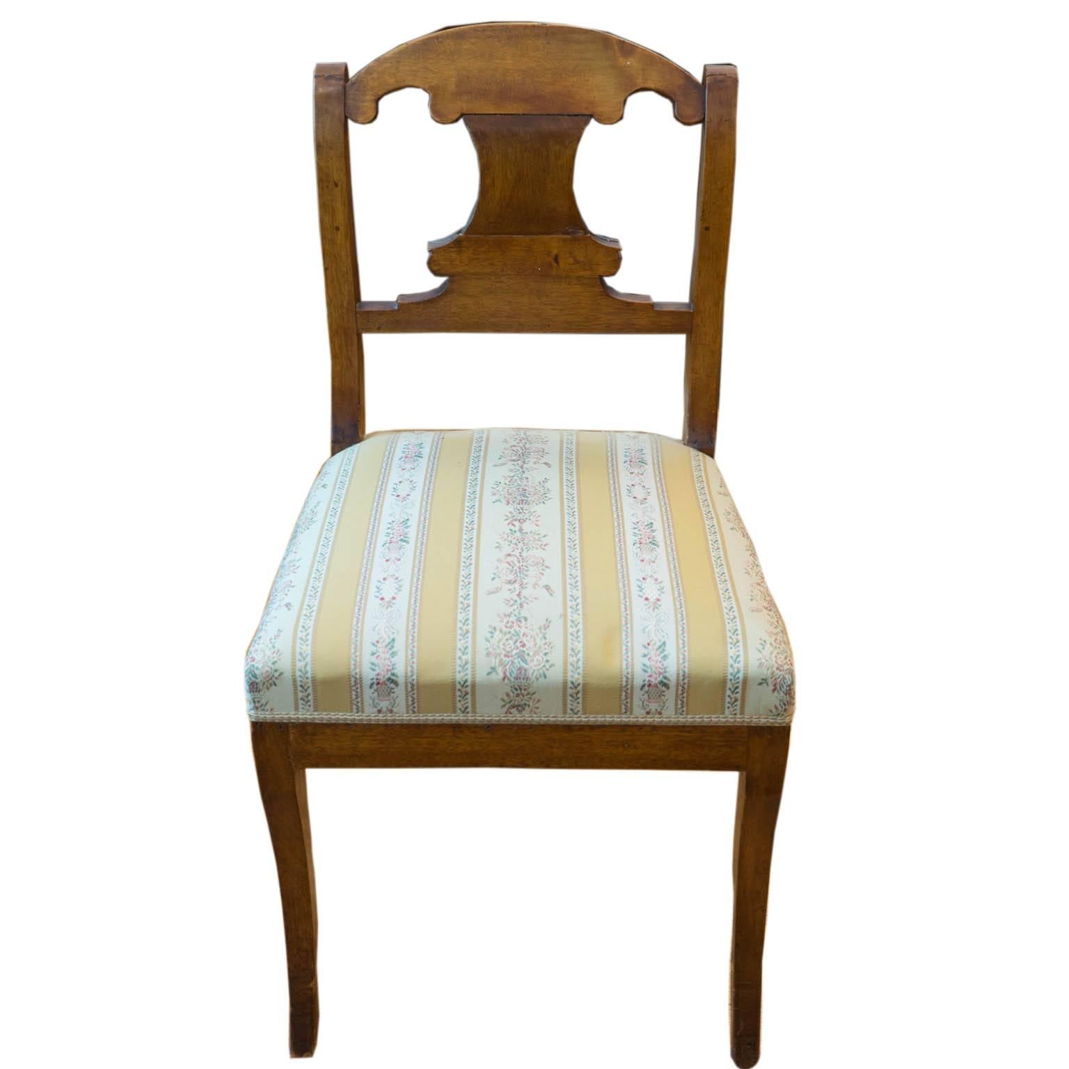 This elegant and sturdy side chair was crafted of solid birch during the reign of King Karl Johan, from whom the period was named. It was reupholstered sometime in its past, perhaps 100 years later, in period appropriate Swedish fabric.