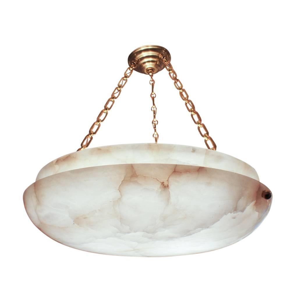 A very textured section of alabaster with golden toned mineral veining, the fixture has been recently rewired on contemporary chains. The use of chains precludes the use of an alabaster canopy, as the chains could scrape the softer alabaster of the